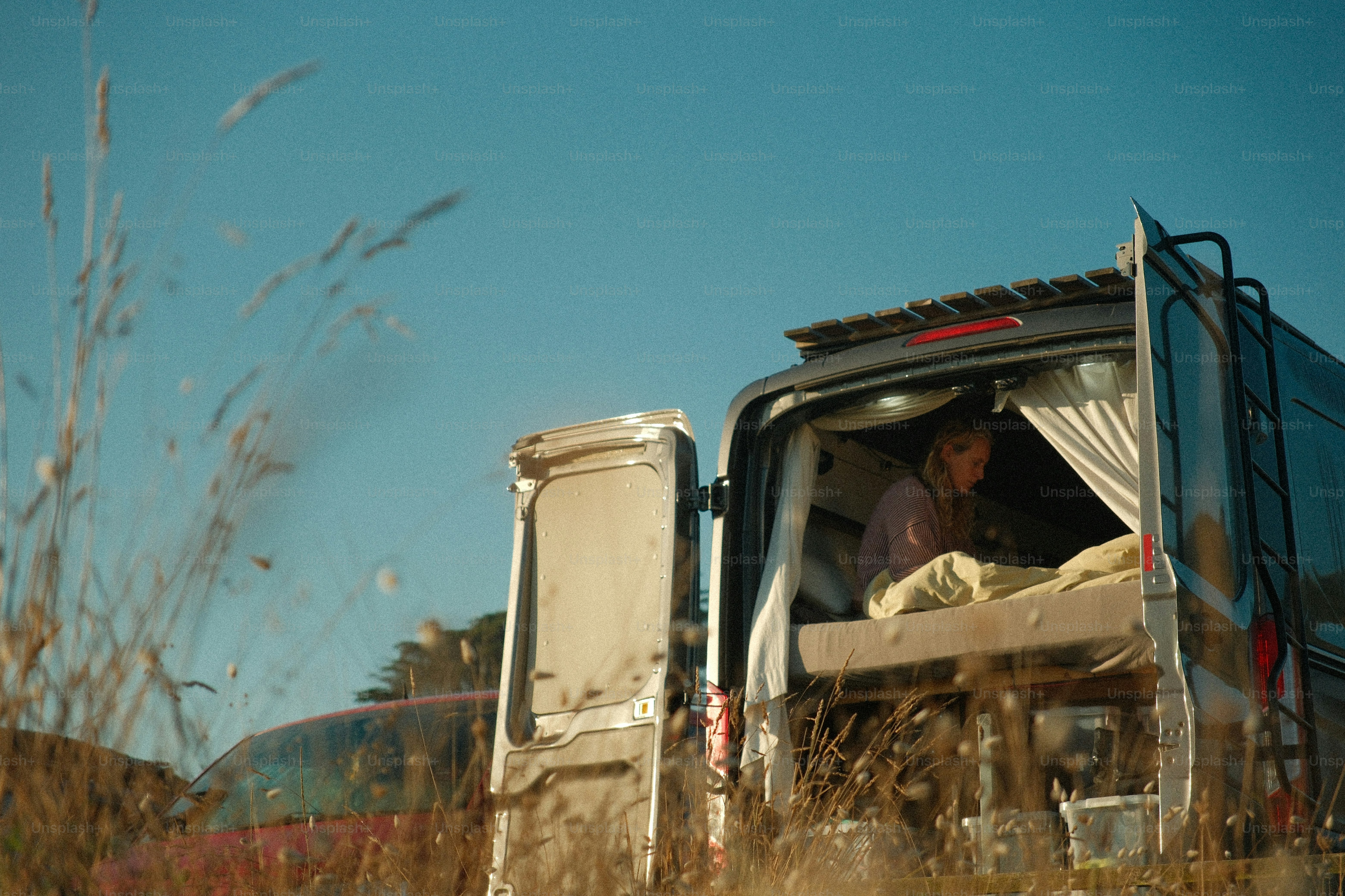 Woman resting inside a camper van outdoors photo – Image on Unsplash