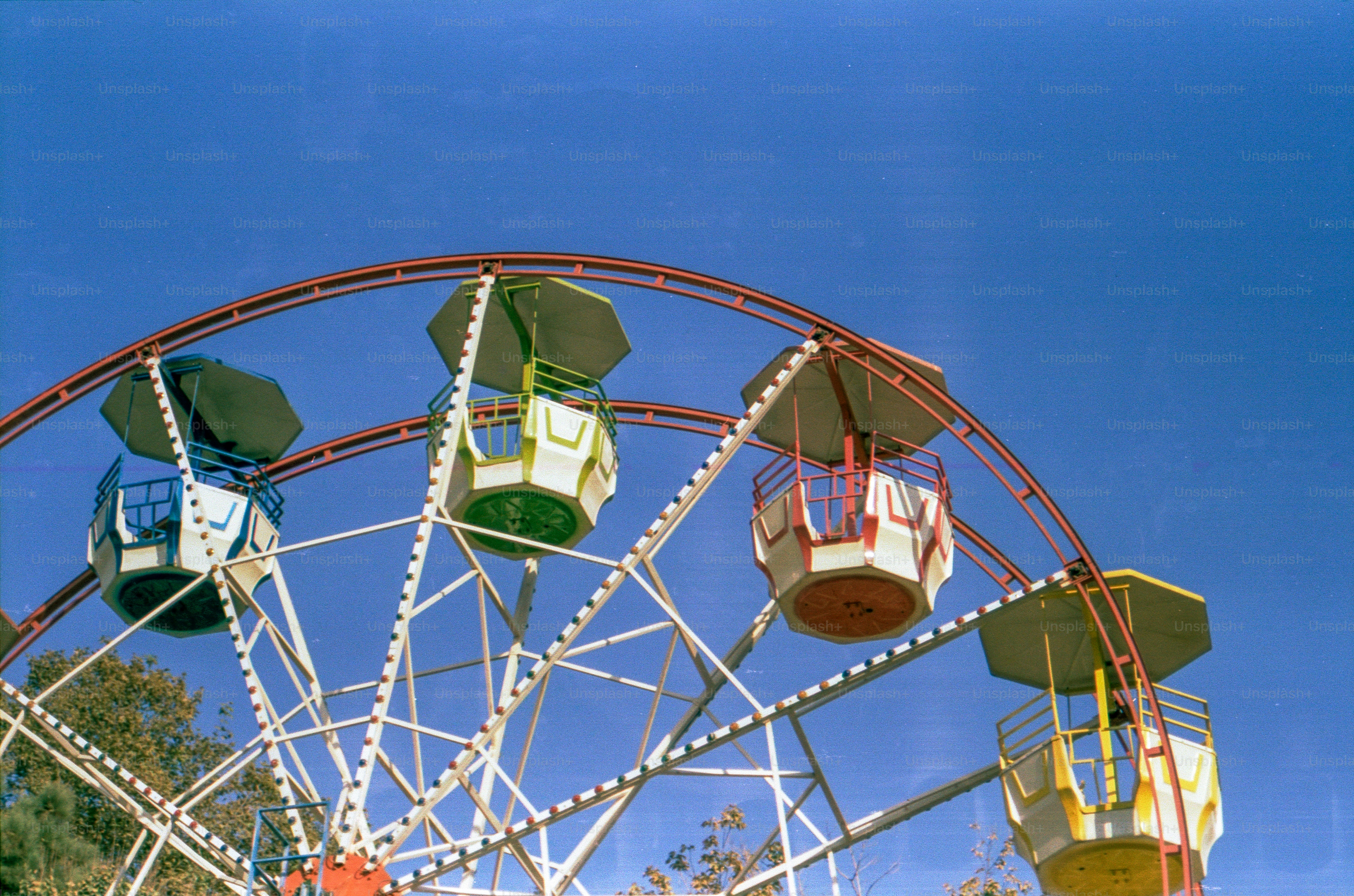 Ferris wheel with colorful cabins against blue sky