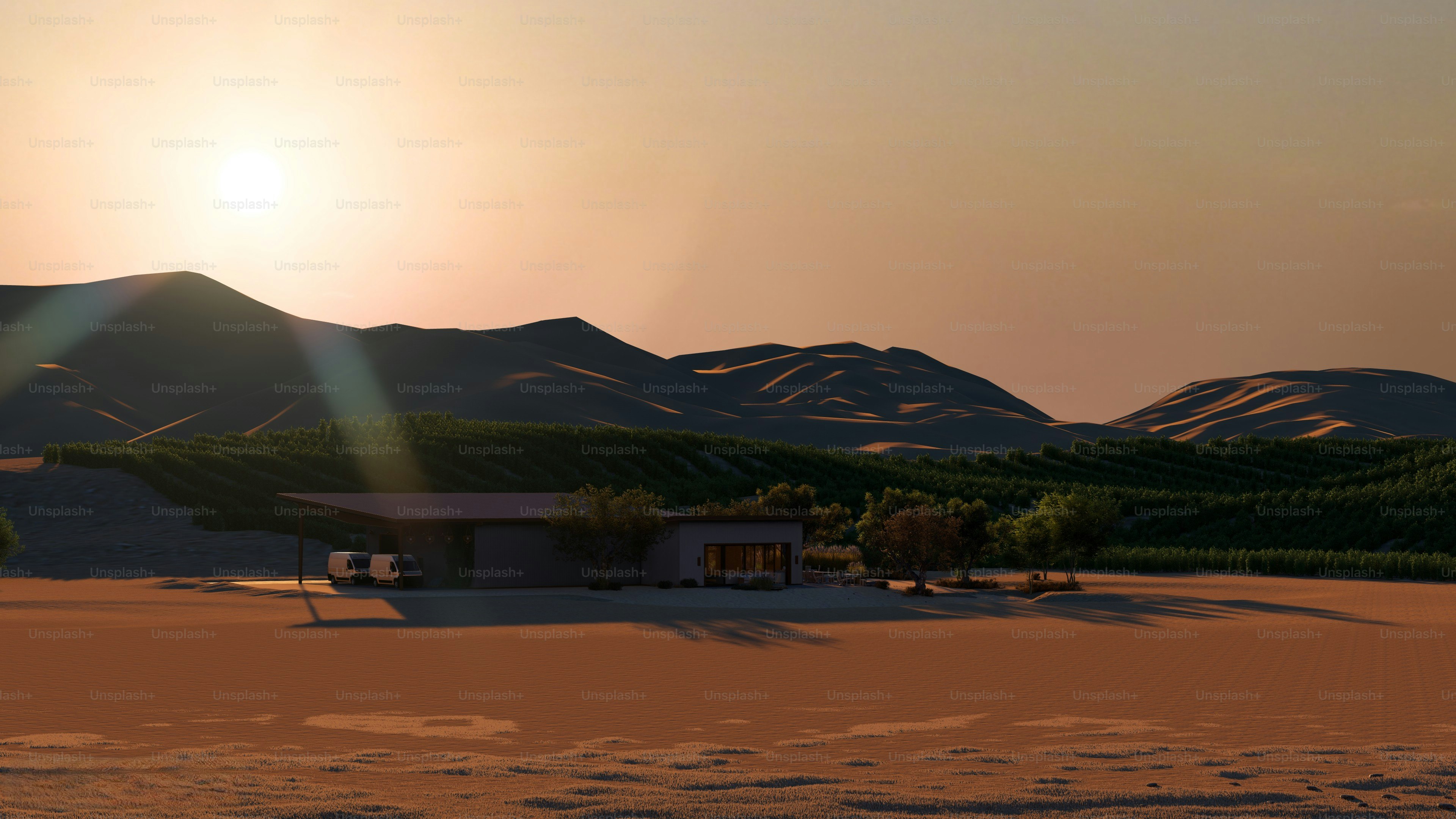 Desert landscape with a building at sunset.