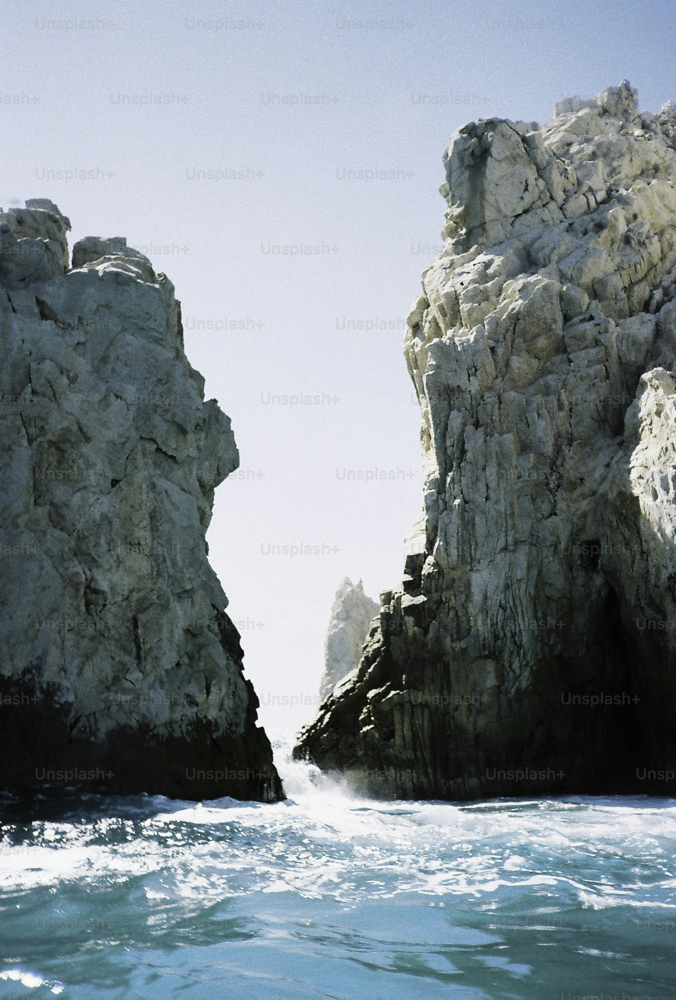 Rocky cliffs rise from turquoise ocean water