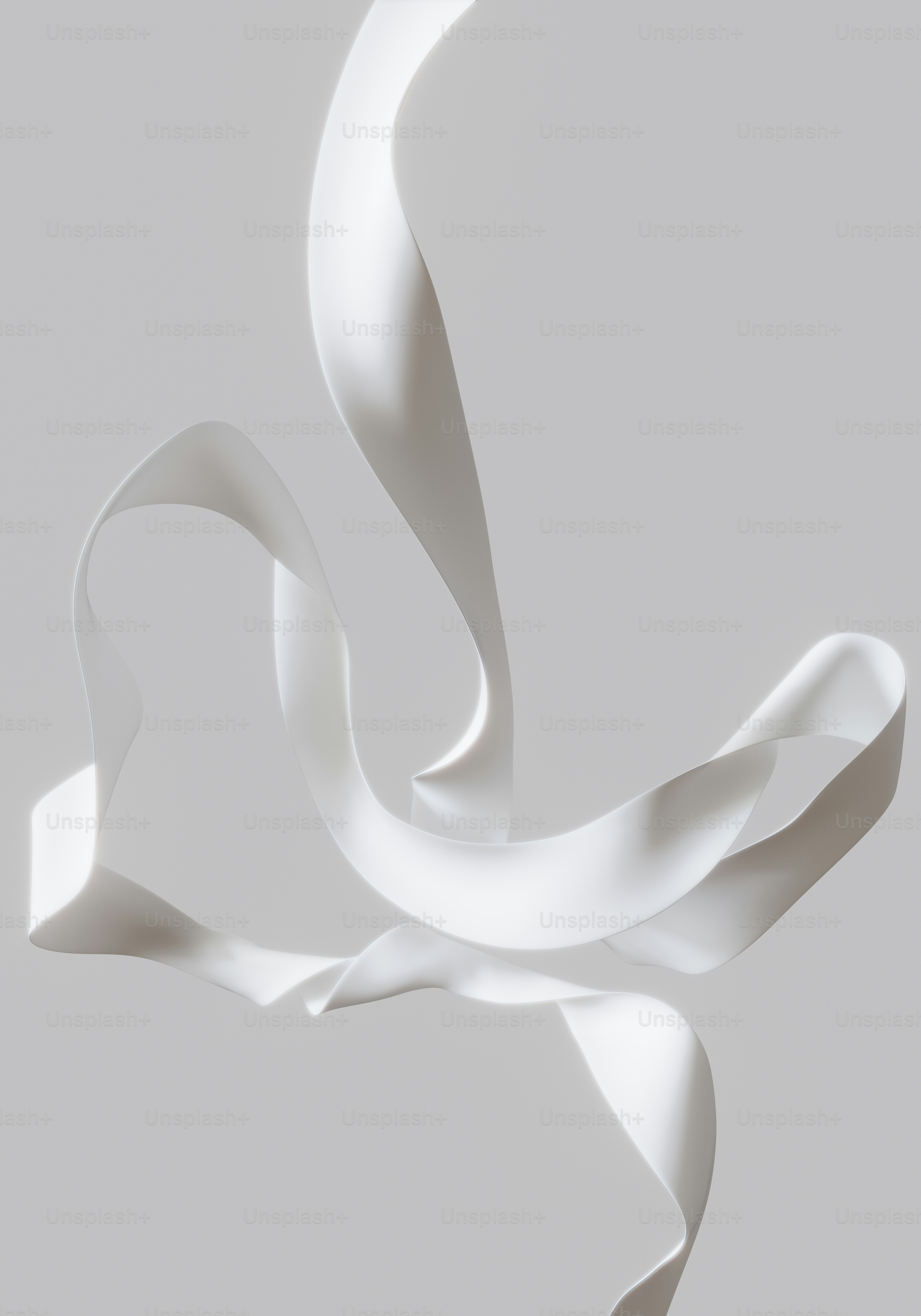 White ribbon gracefully flowing against a gray background