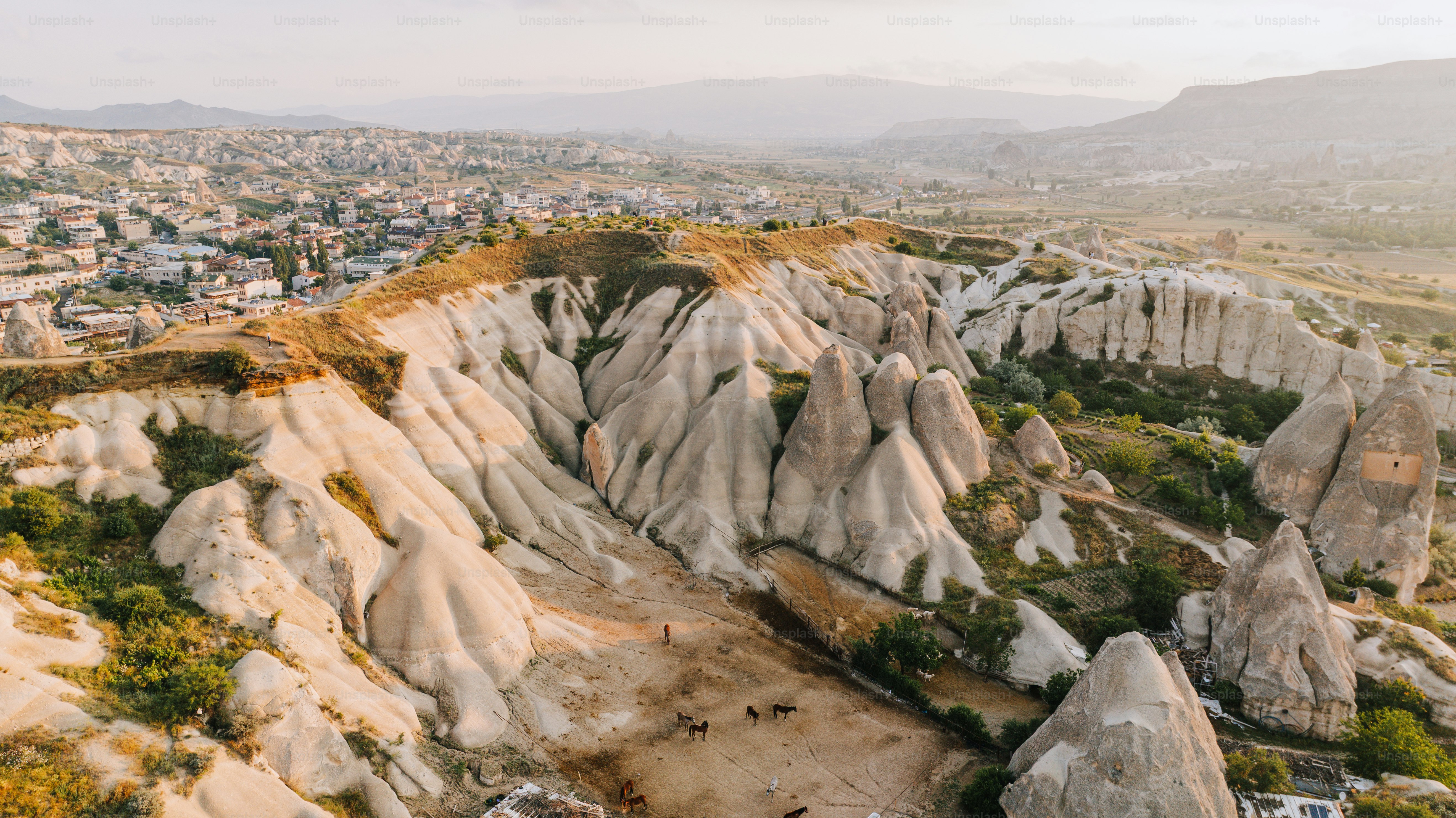 Unique rock formations in a valley with a town.