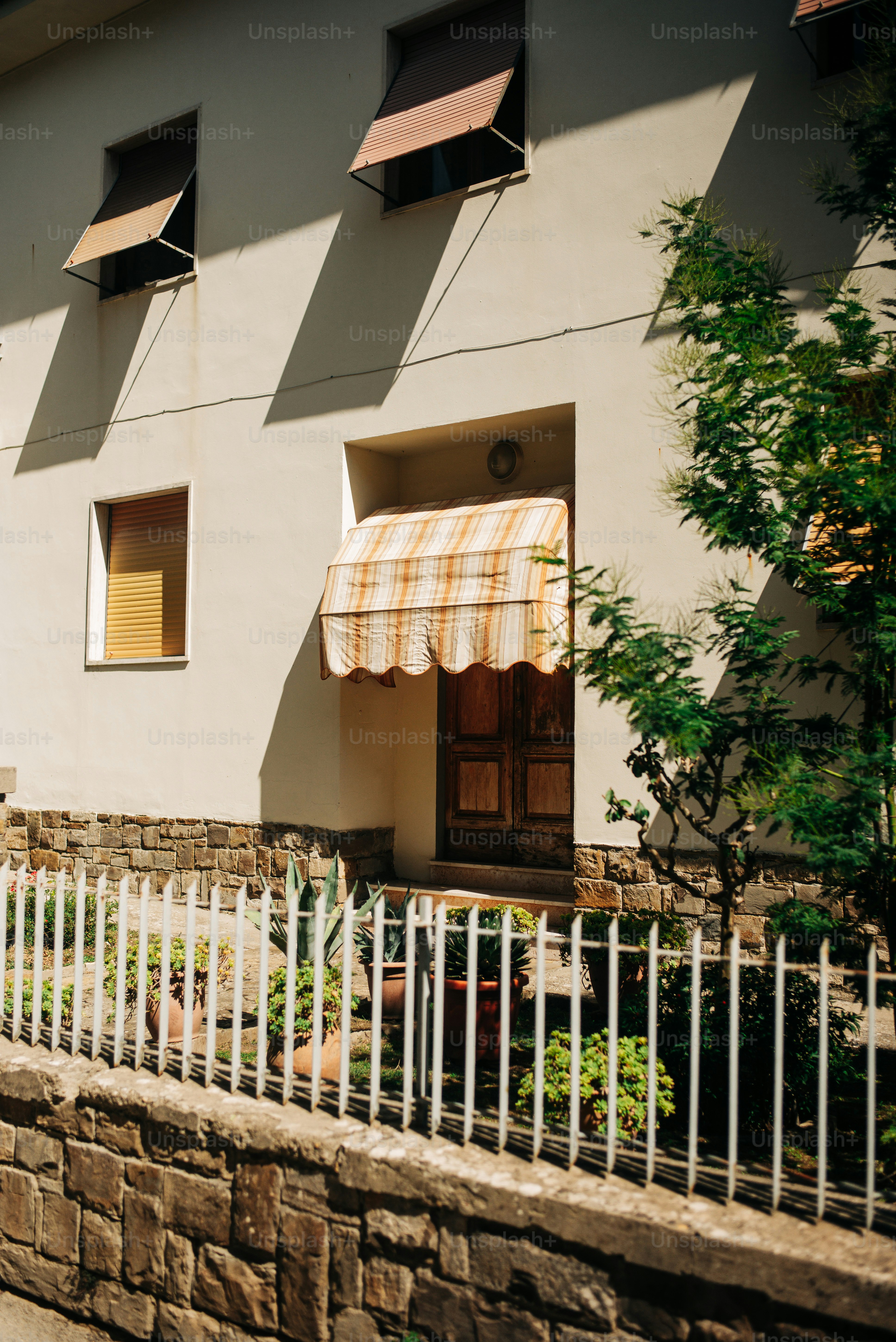 Building entrance with awning and white fence