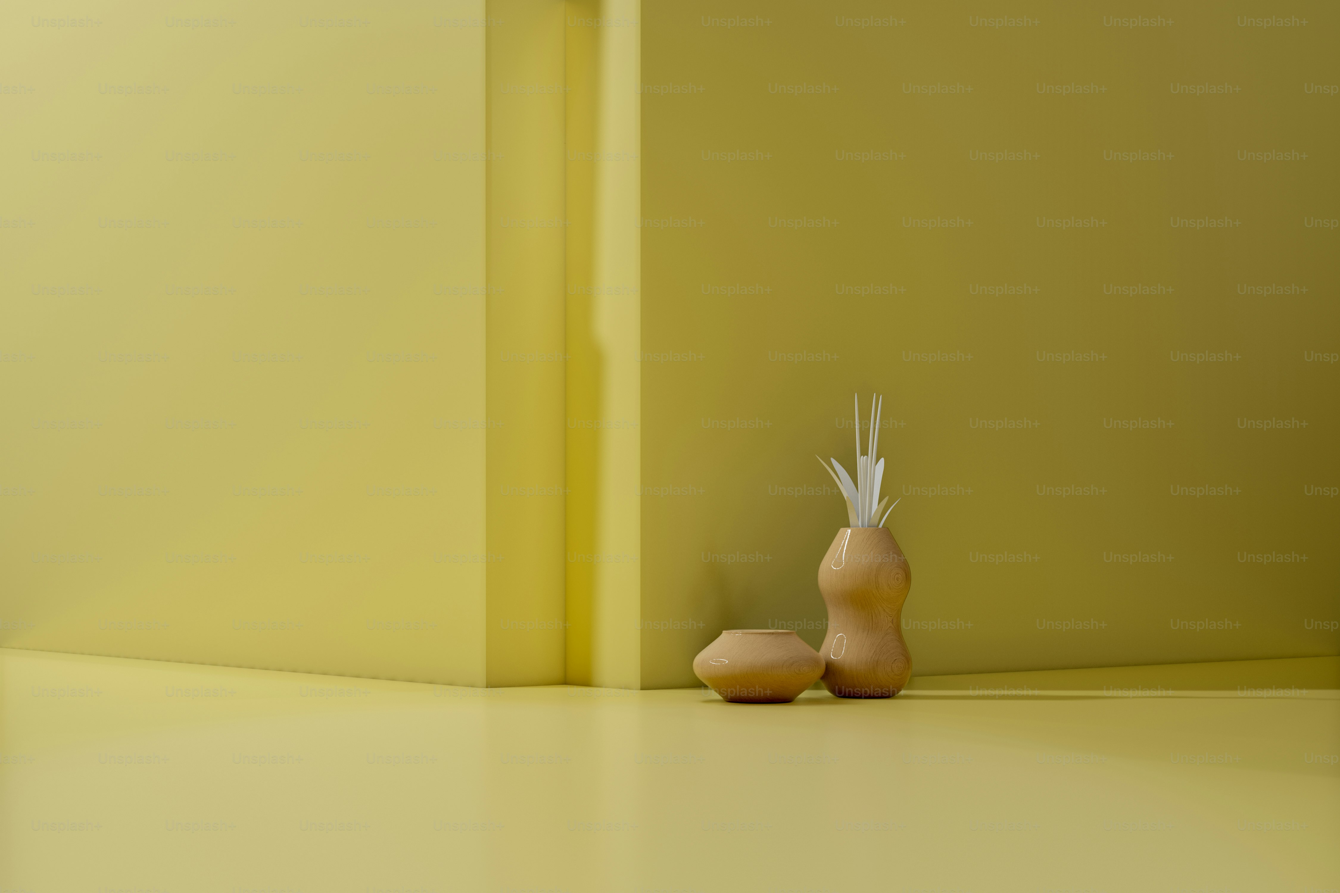 Two abstract objects on a yellow surface.