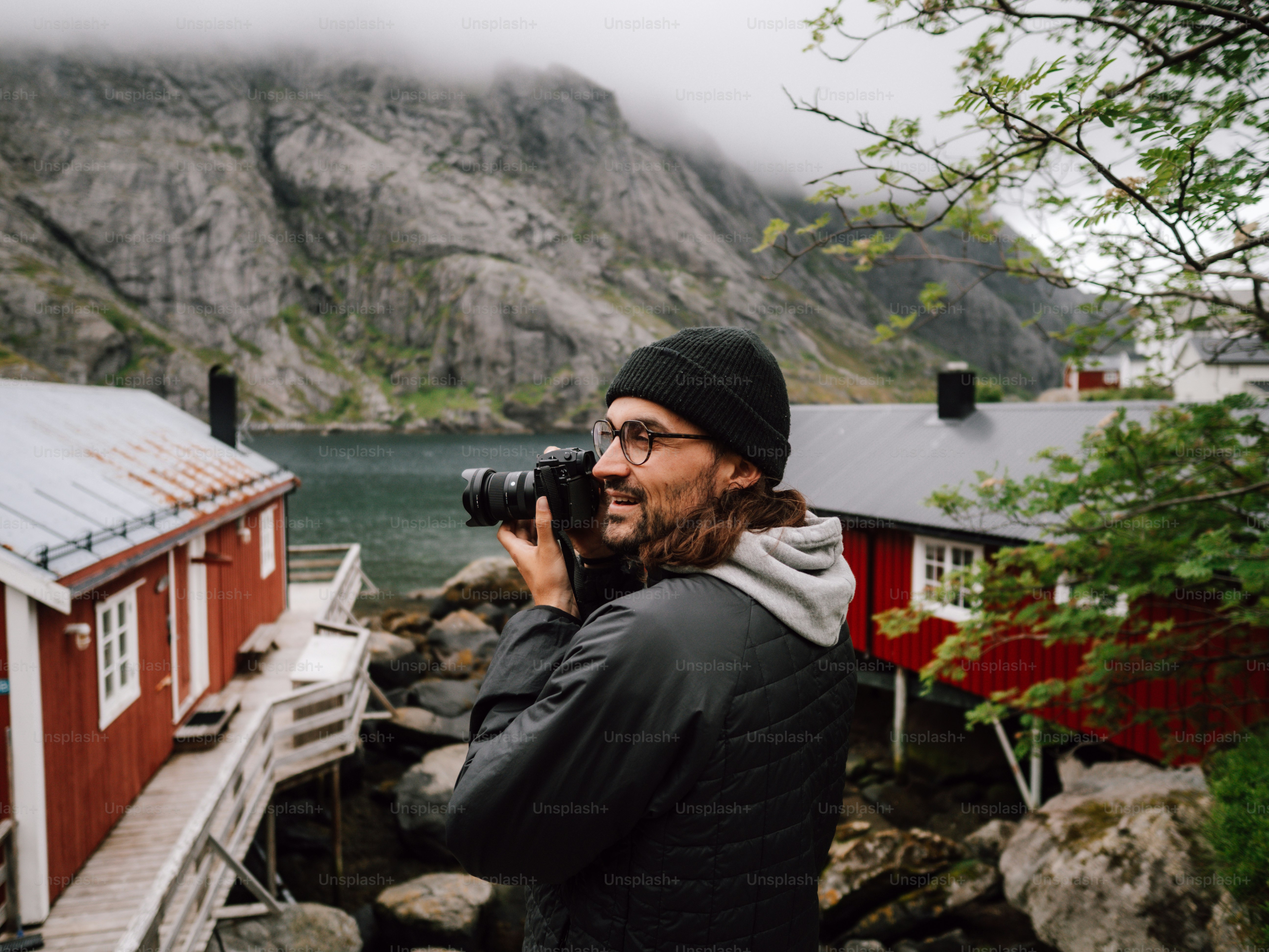 Man with camera photographing scenic coastal village
