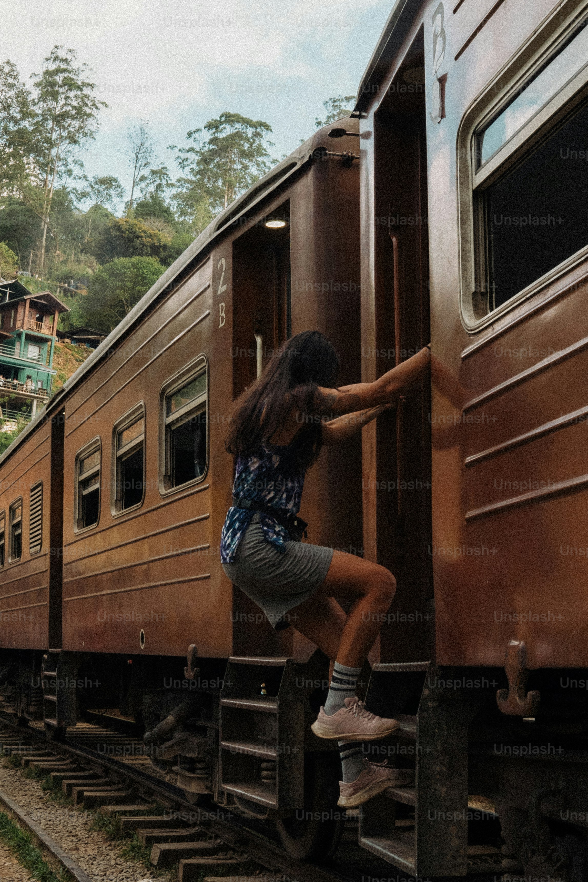 Woman climbing onto a vintage train carriage