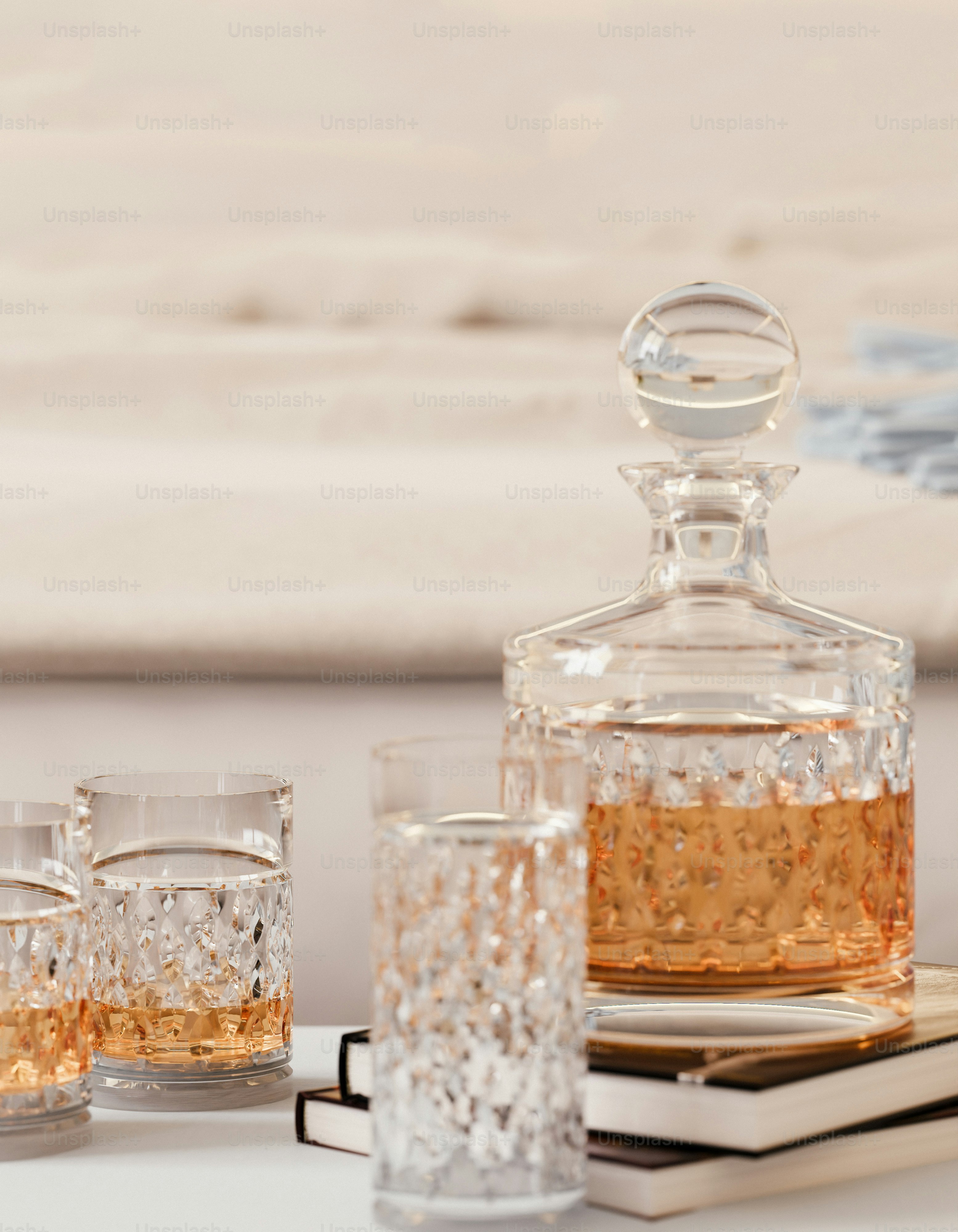 Crystal decanter and glasses filled with amber liquid.