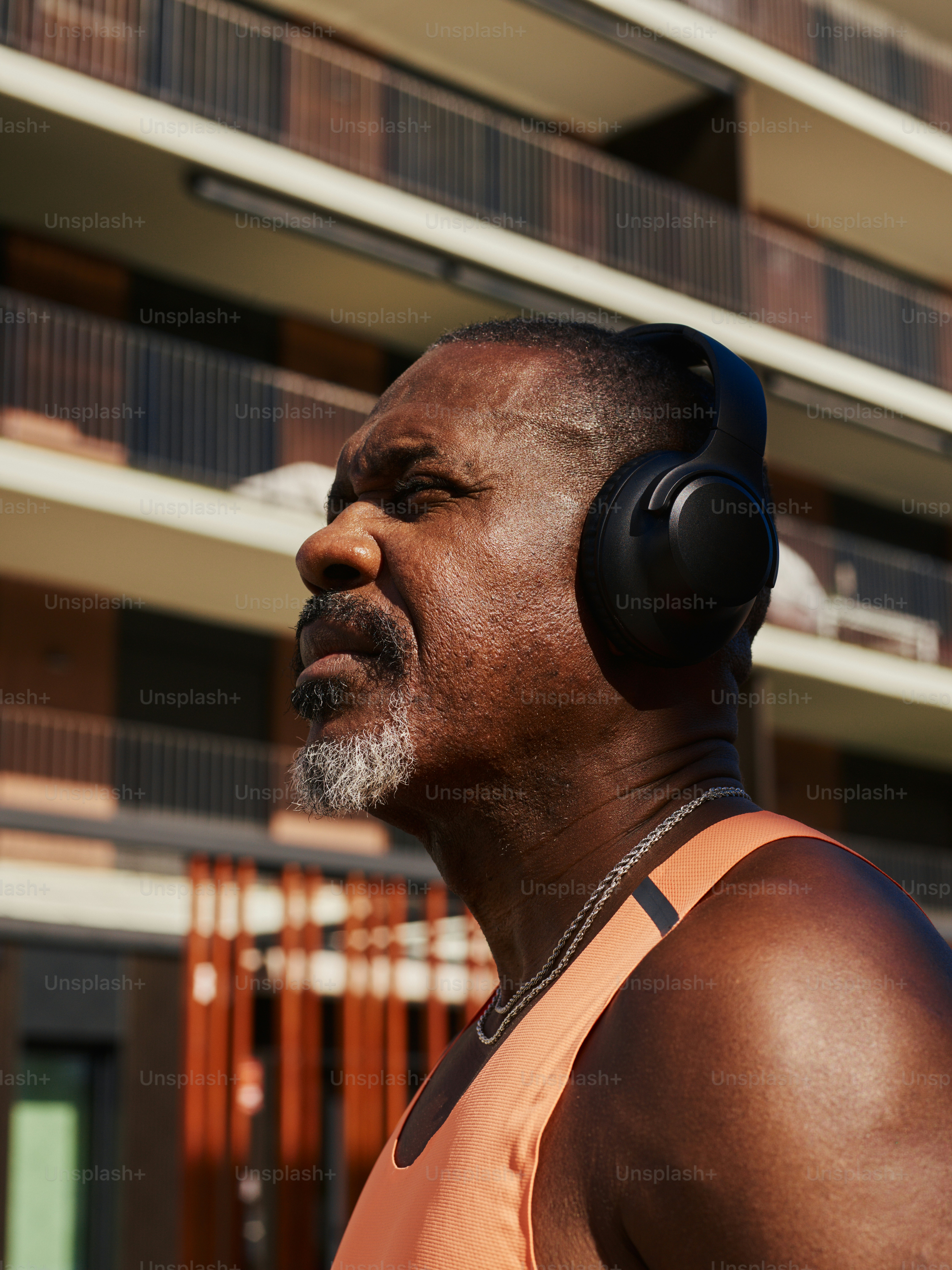 Mann mit Kopfhörern hört draußen Musik.