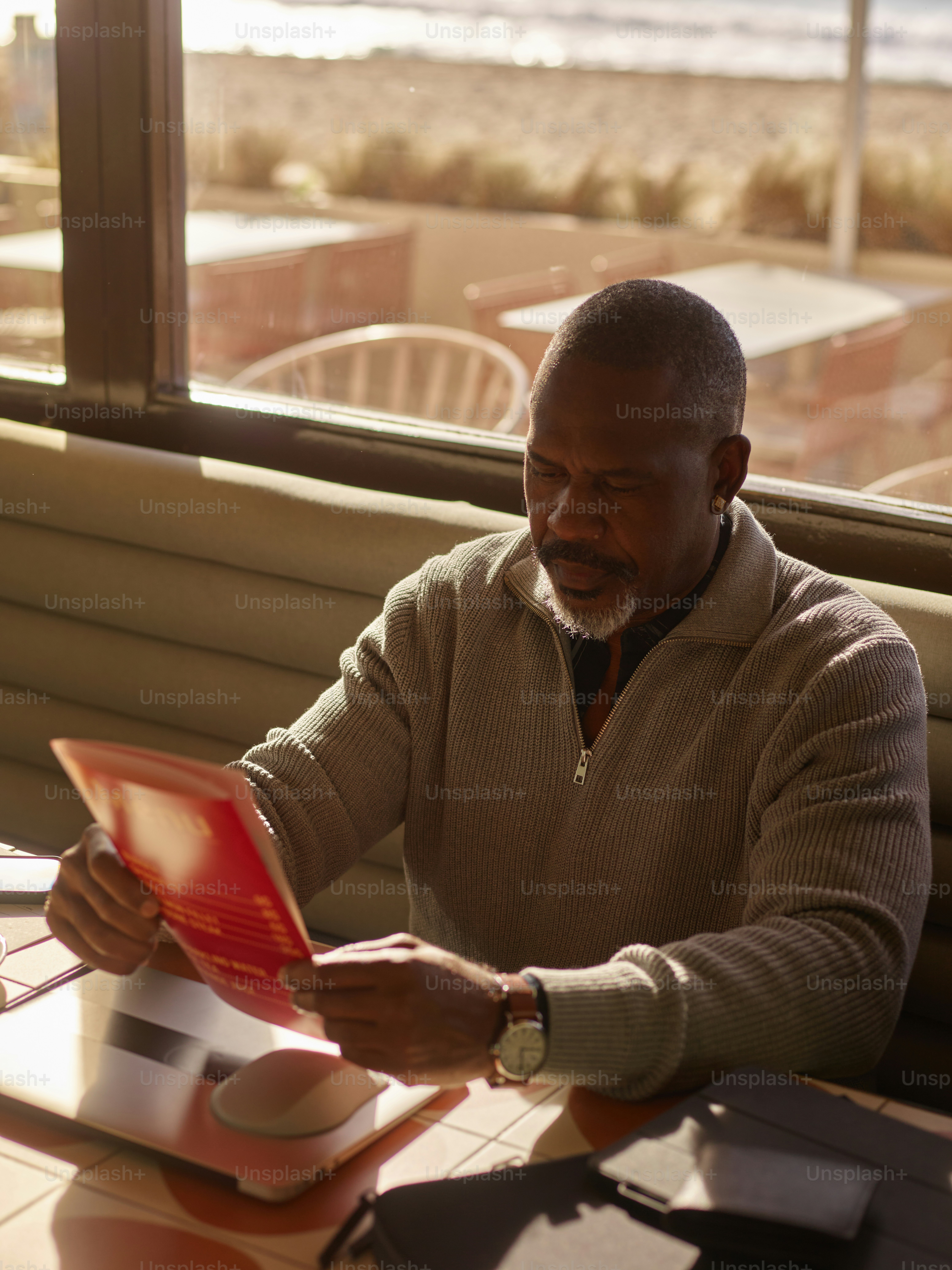 Man reading a menu at a seaside restaurant. photo – Restaurant Image on ...