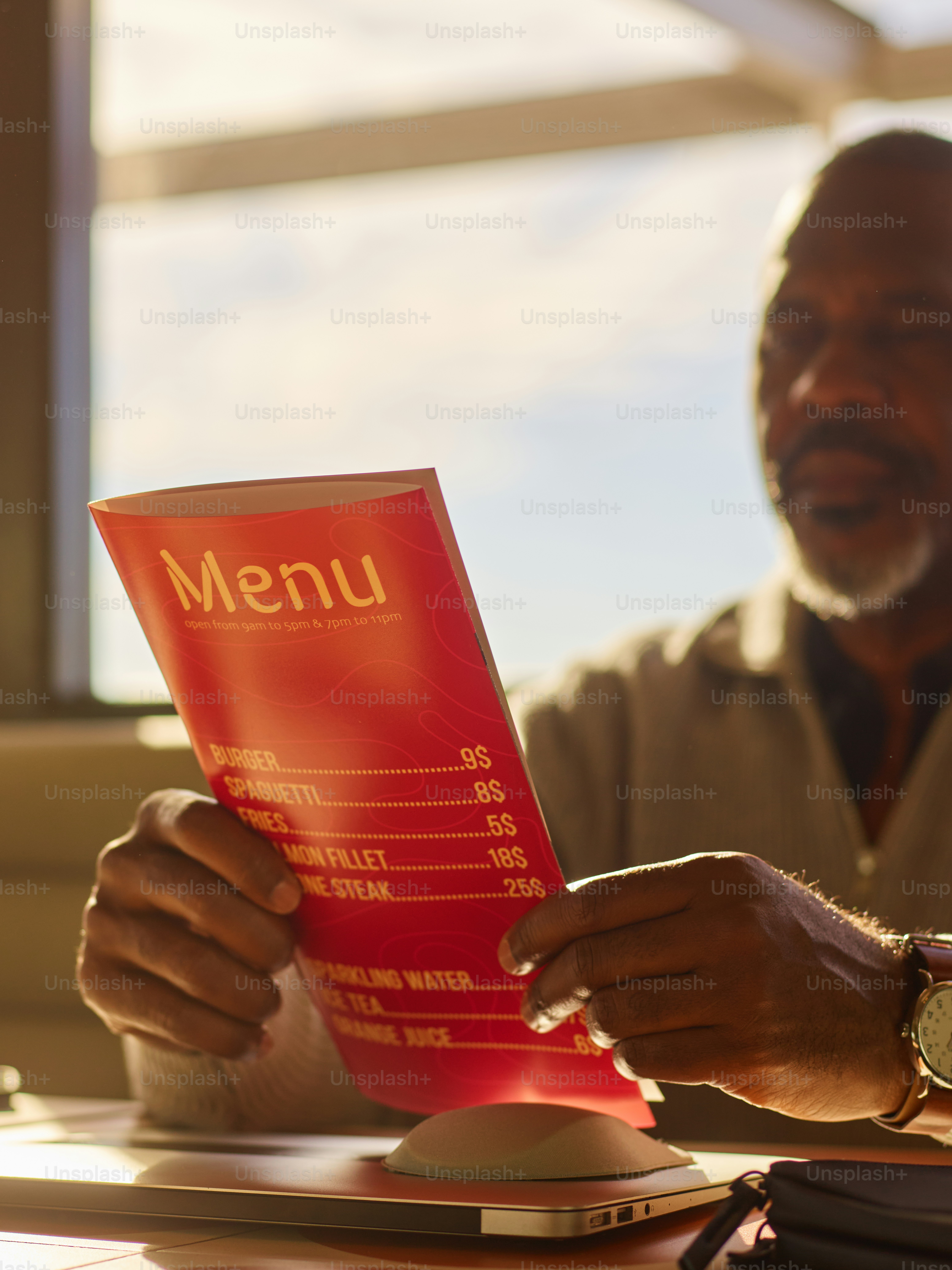 Man reading a red menu at a table photo – Business Image on Unsplash