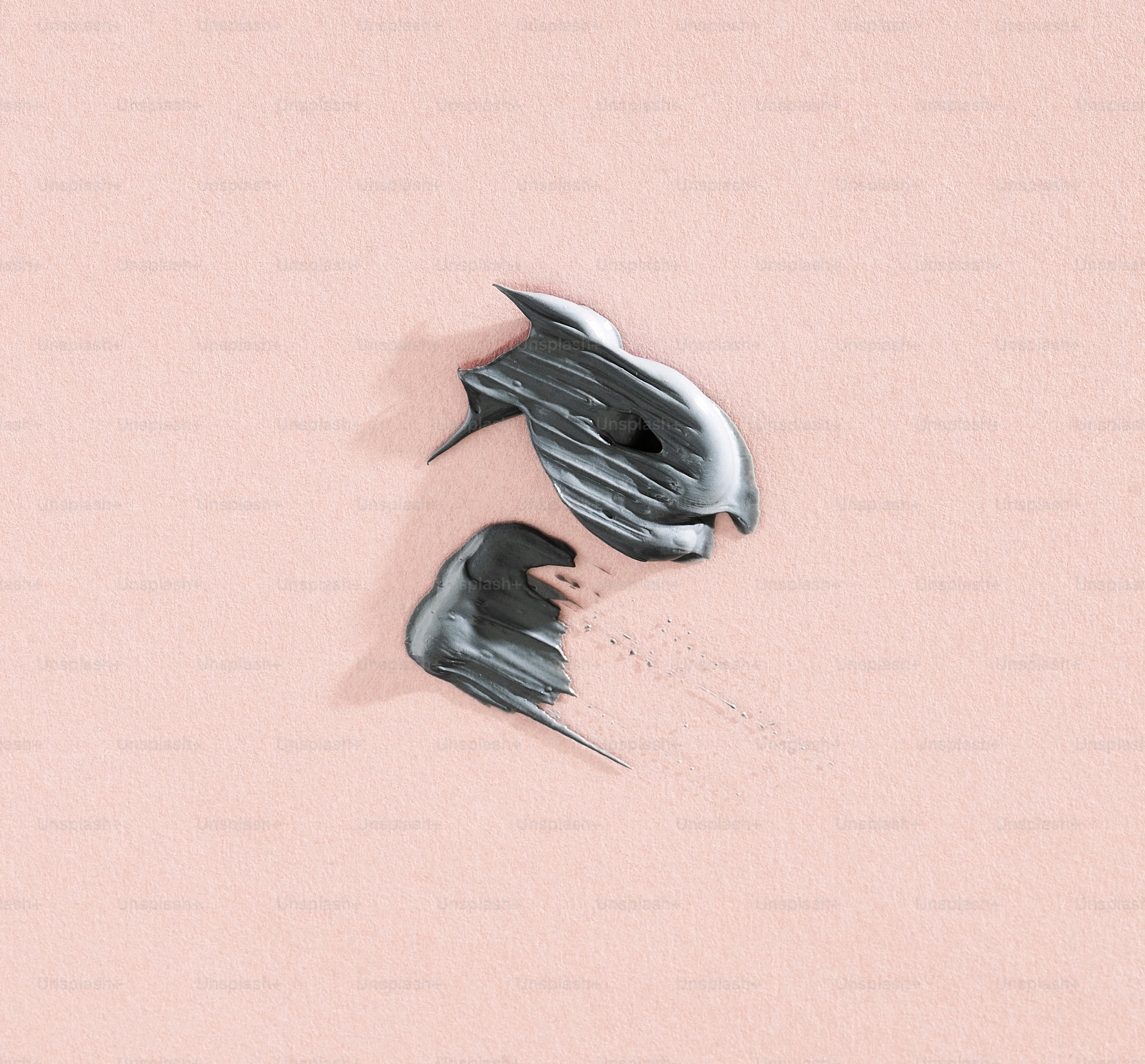 Two abstract metallic shapes on pink background