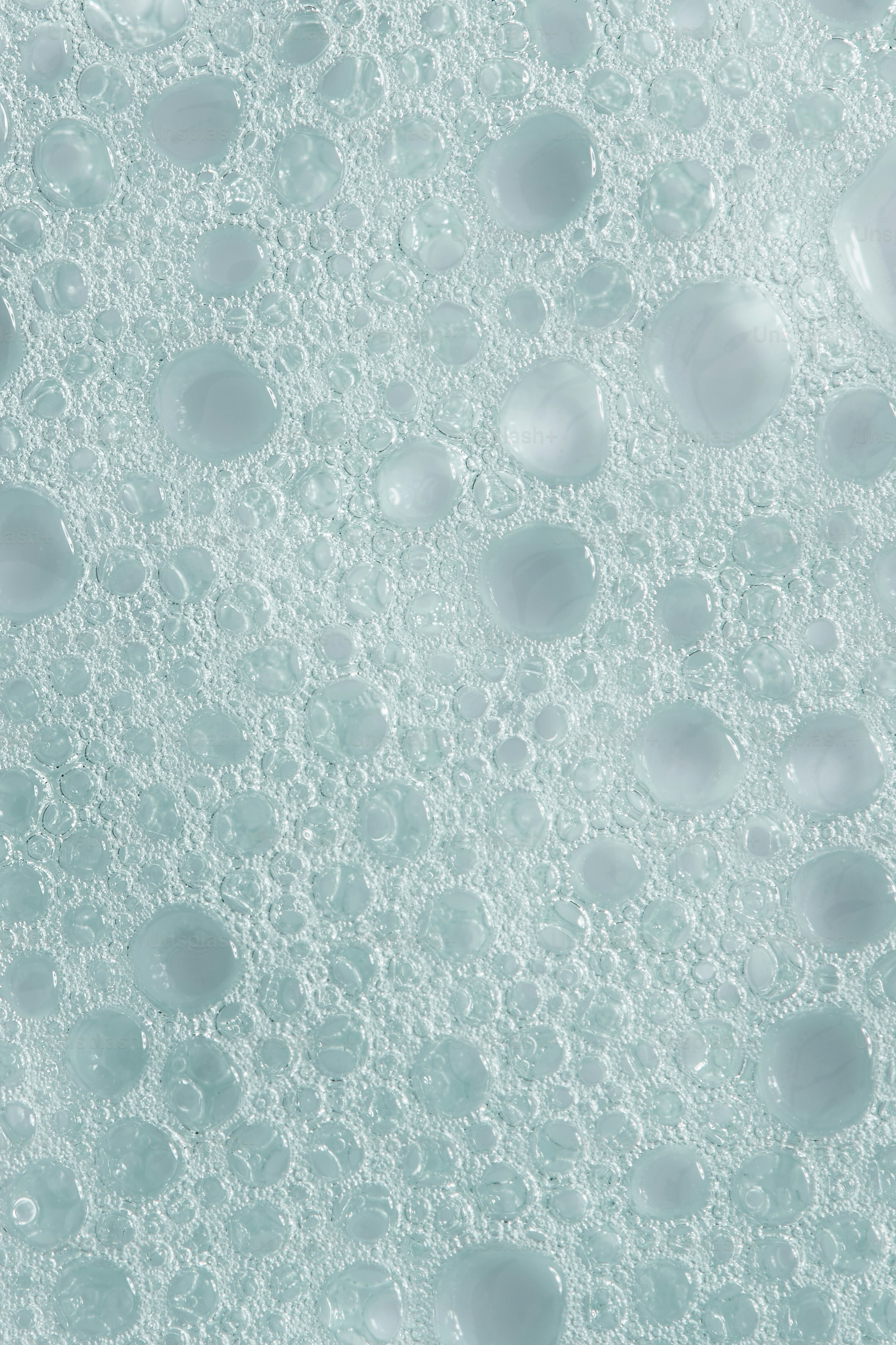 Close-up of light blue soap bubbles and foam