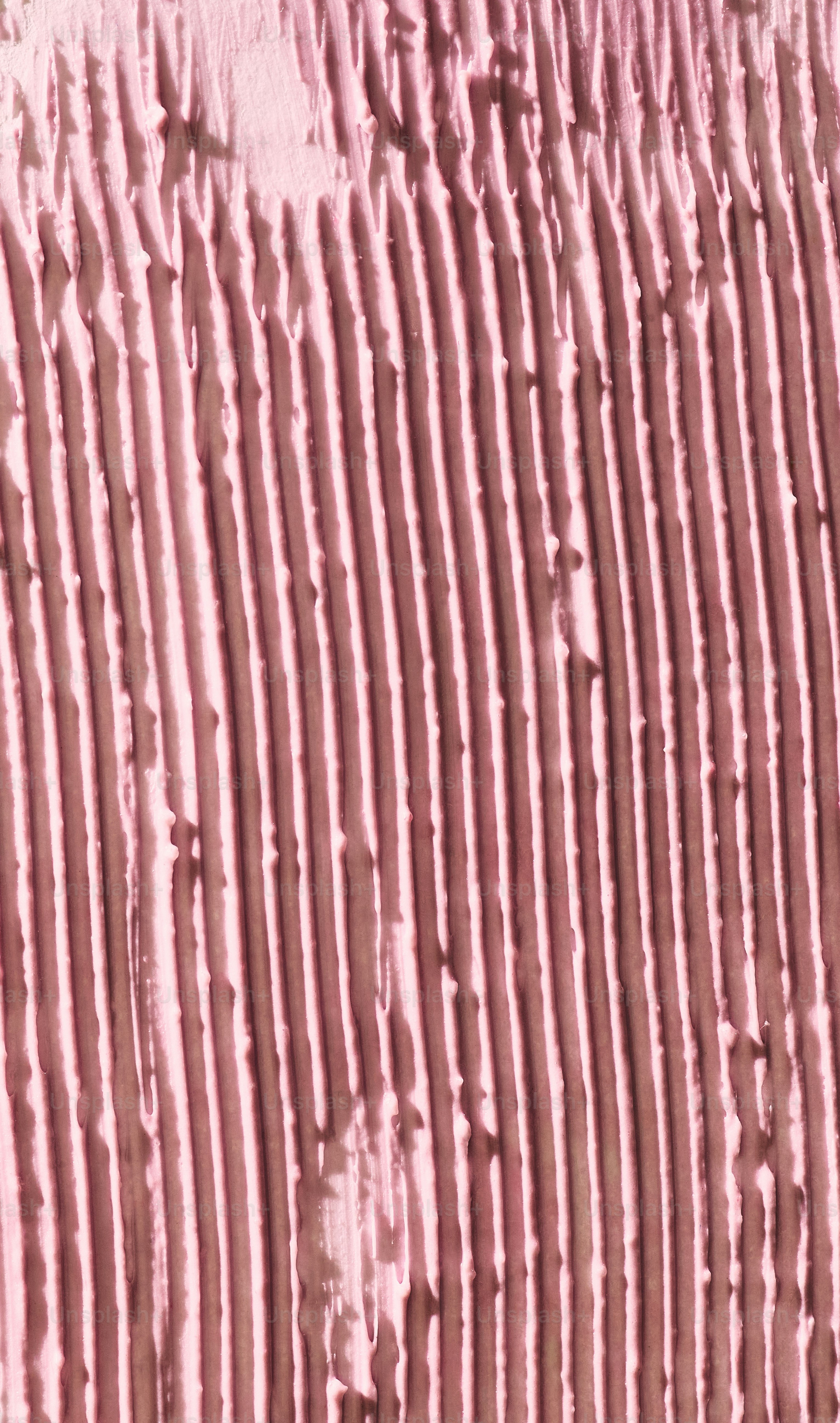 Close-up of textured pink surface with vertical lines.