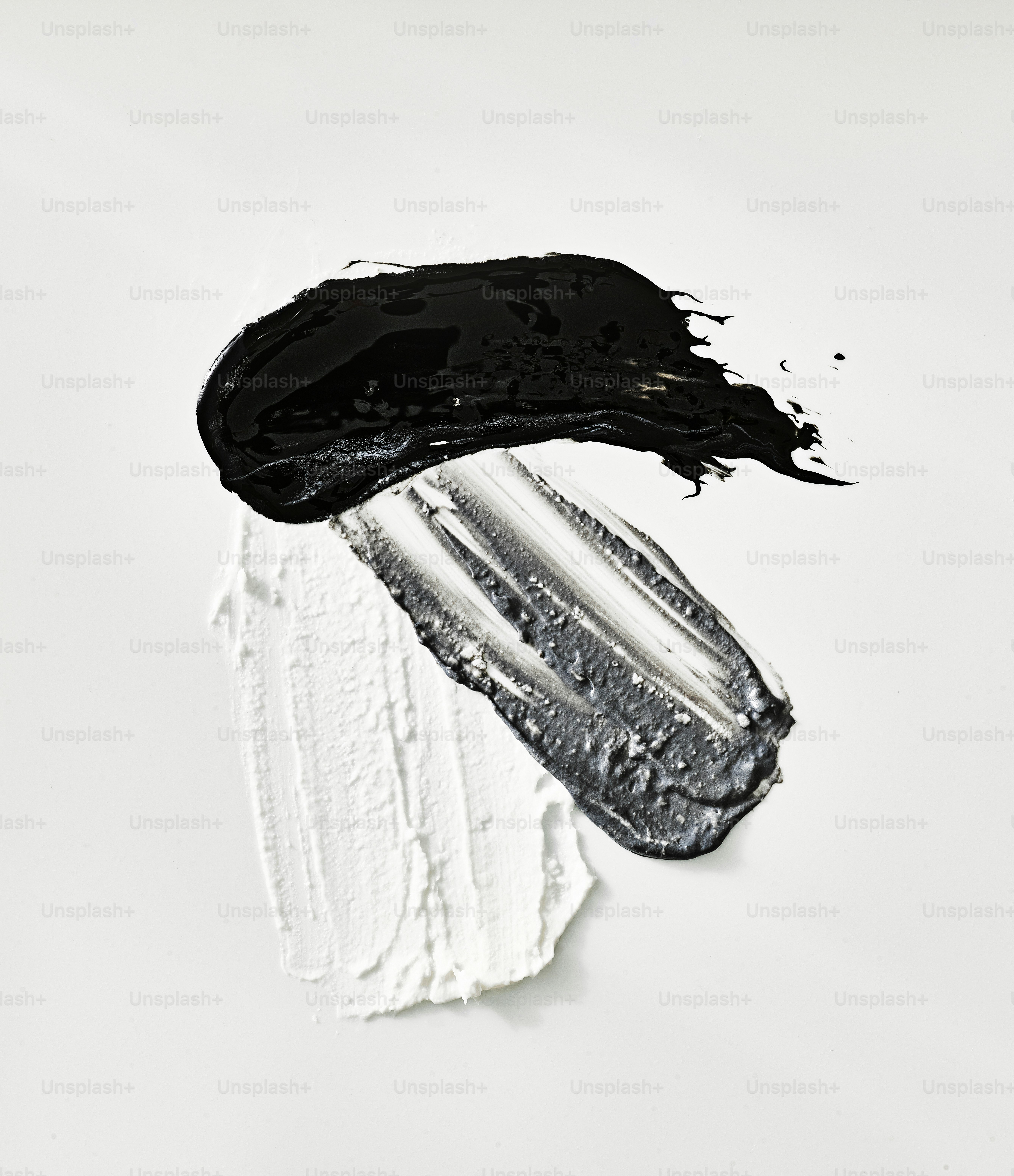 Black and white paint strokes on white background