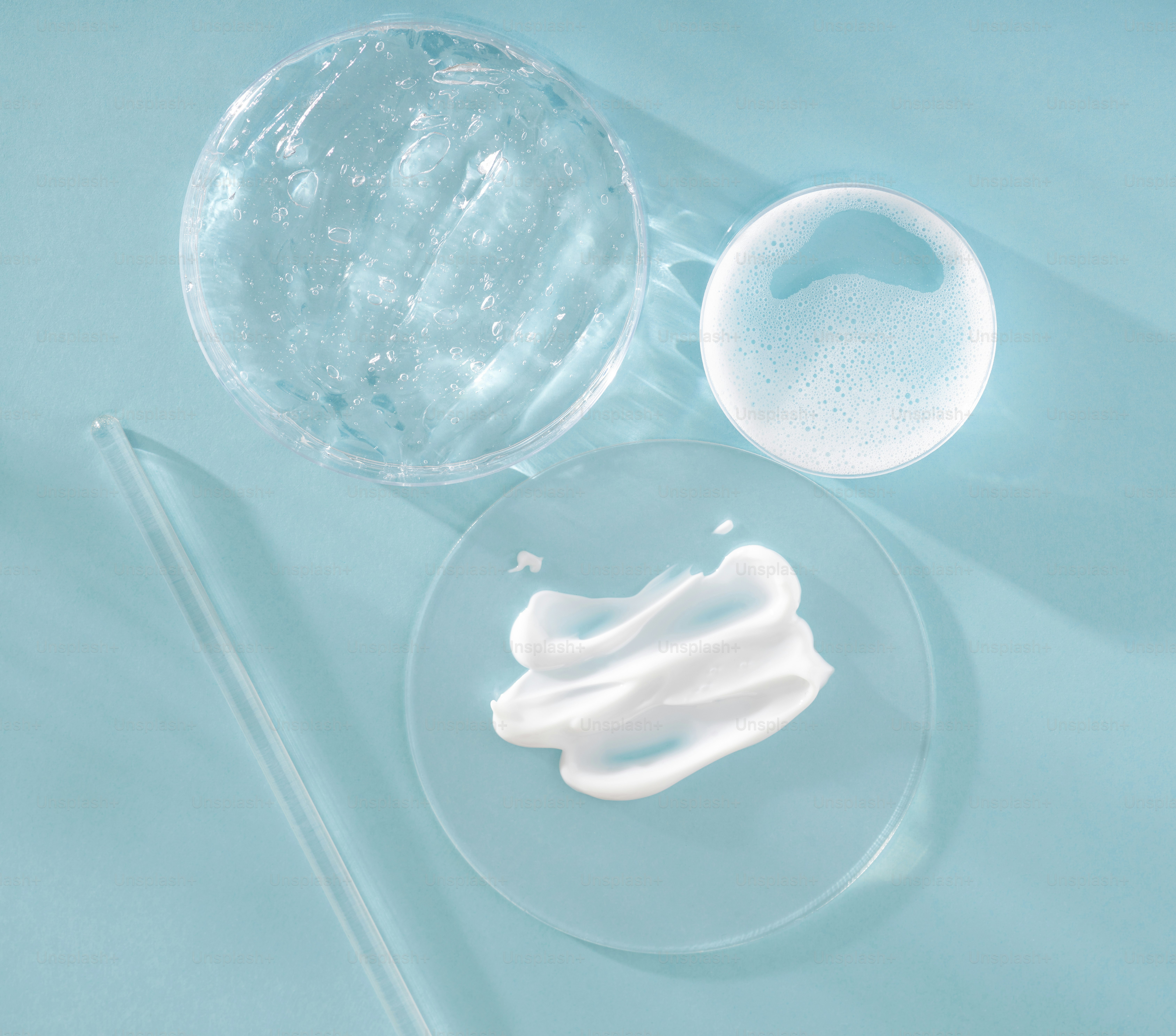 White cream and clear liquids in lab dishes