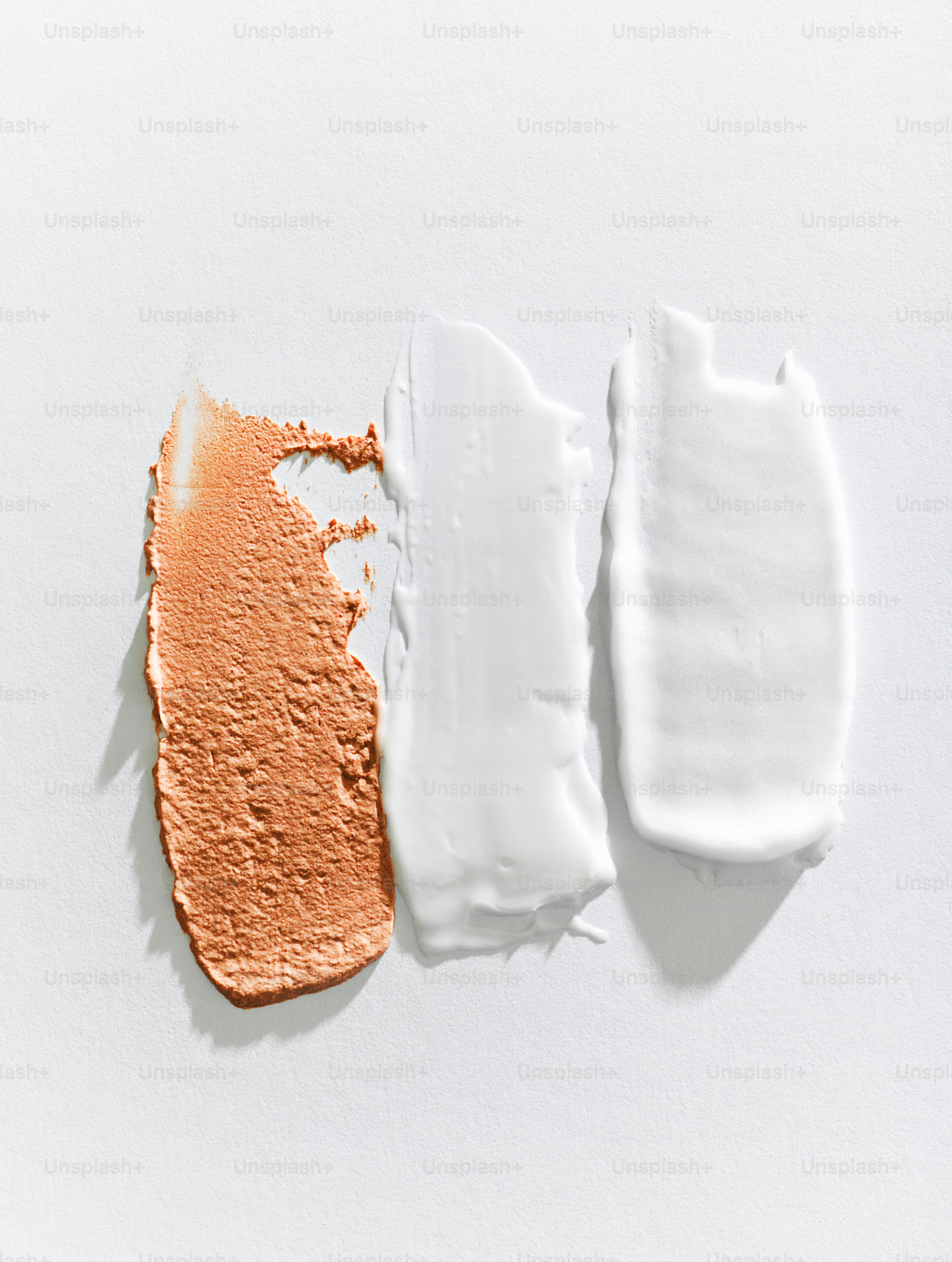 Three cosmetic swatches on a white background.
