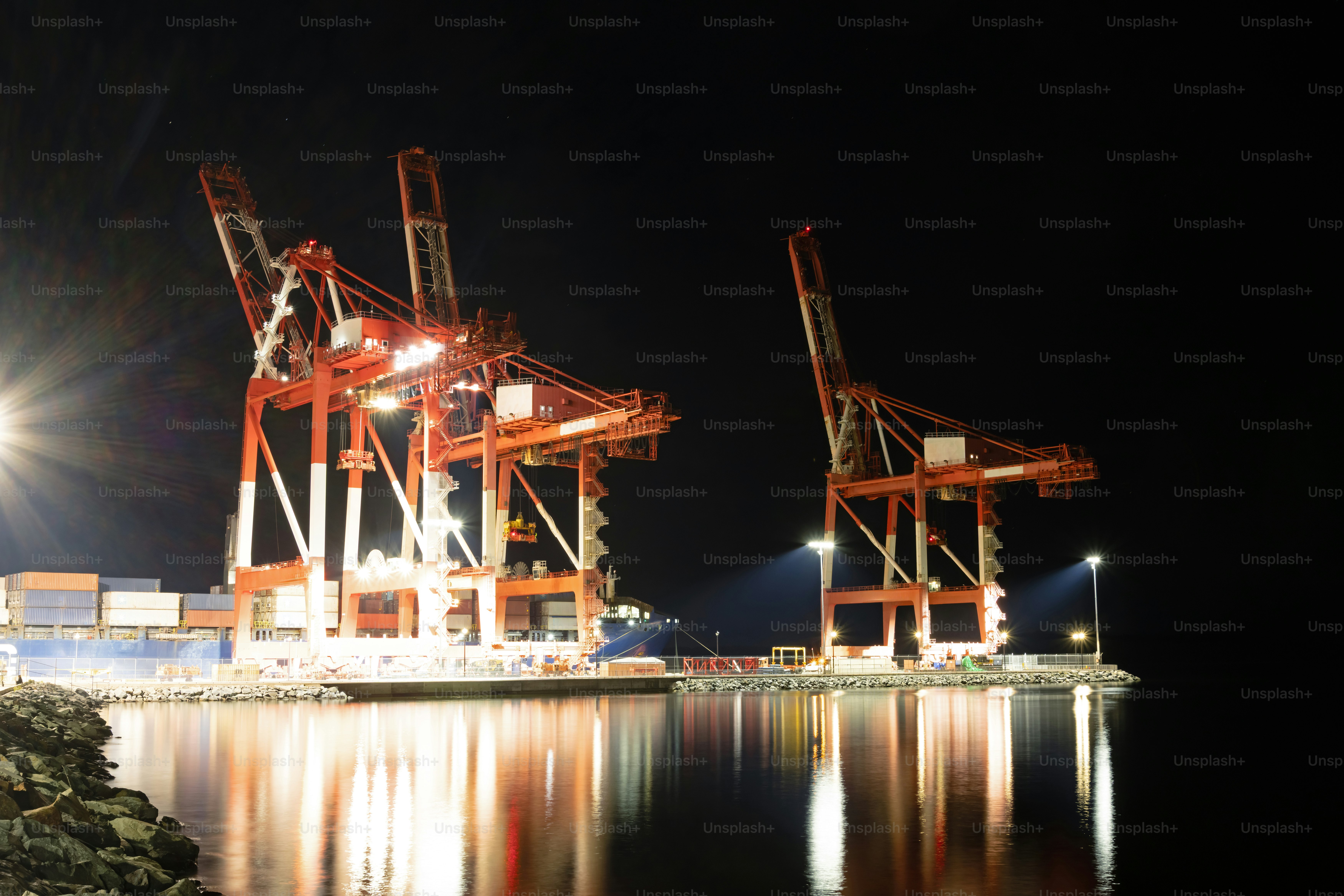 Tall gantry cranes at the end of terminal wharf.