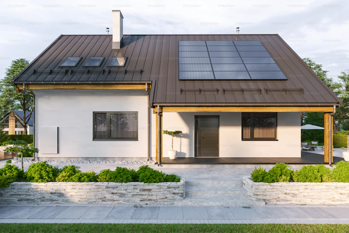 Modern home with solar panels and a wall battery for energy storage