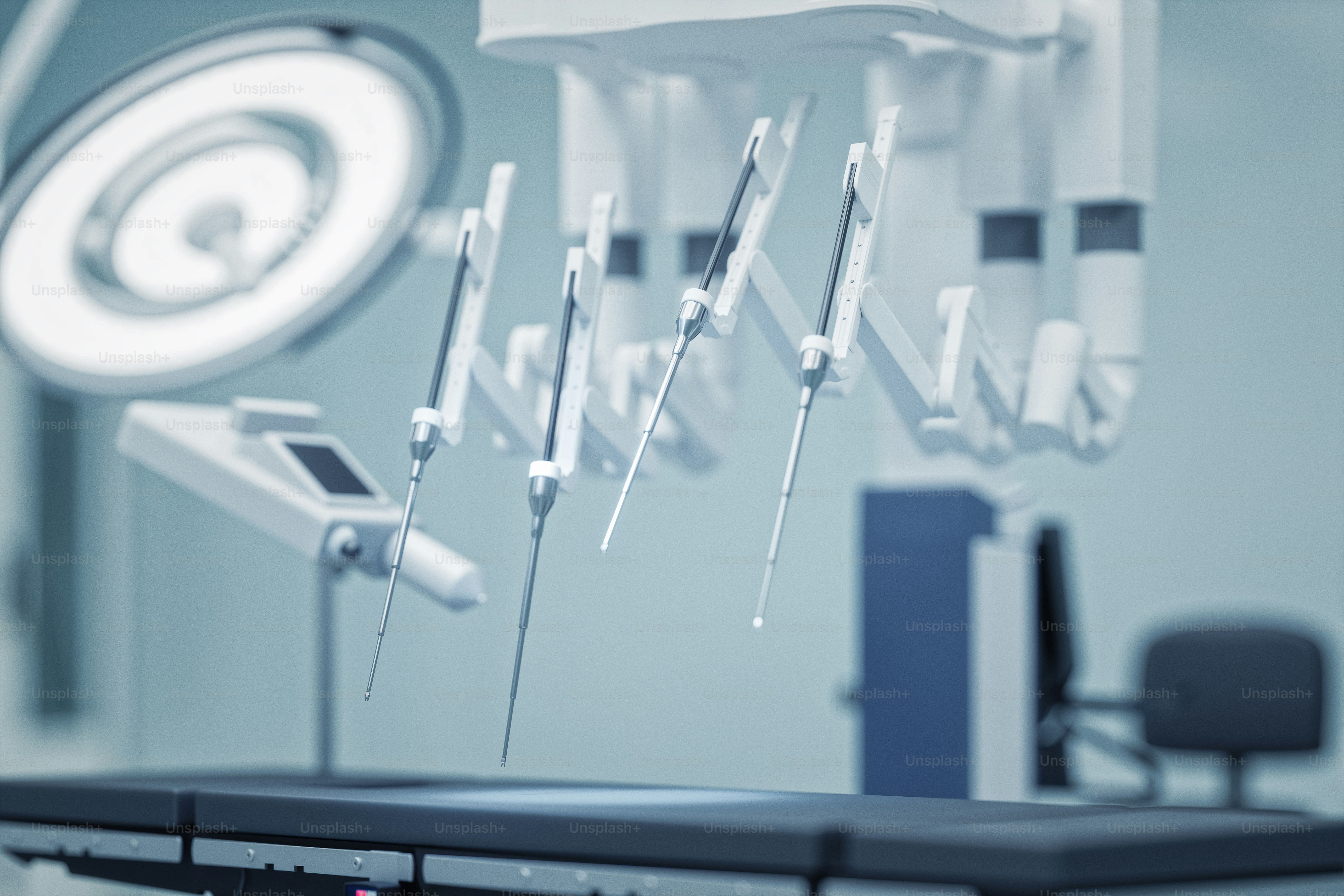Close-up view of robotic surgical arms in an operating room. photo ...
