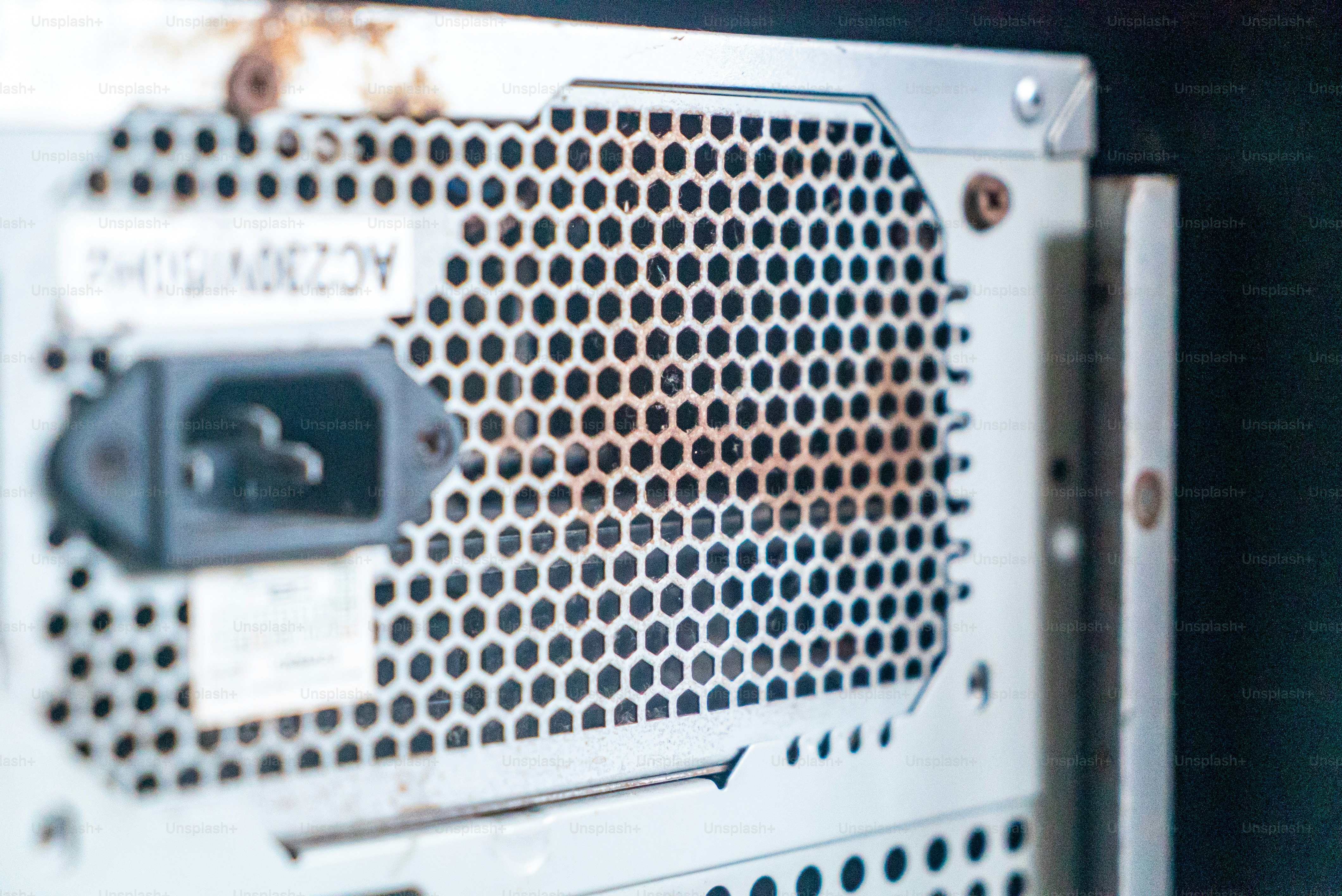 This close-up image showcases the back panel of a computer server, highlighting the intricate design and ventilation features essential for effective cooling and connectivity.