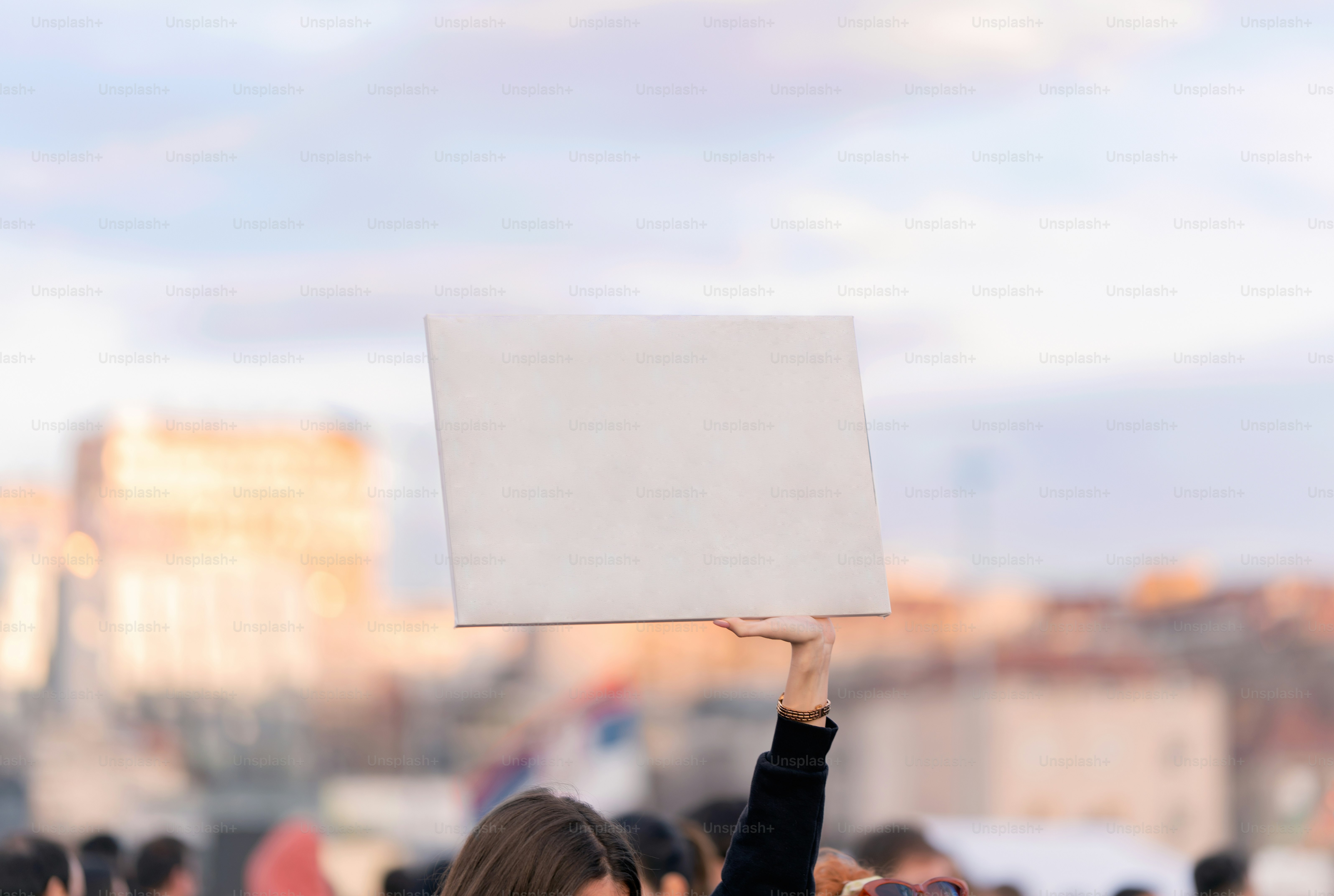 Young woman activist holding blank board photo – City Image on Unsplash