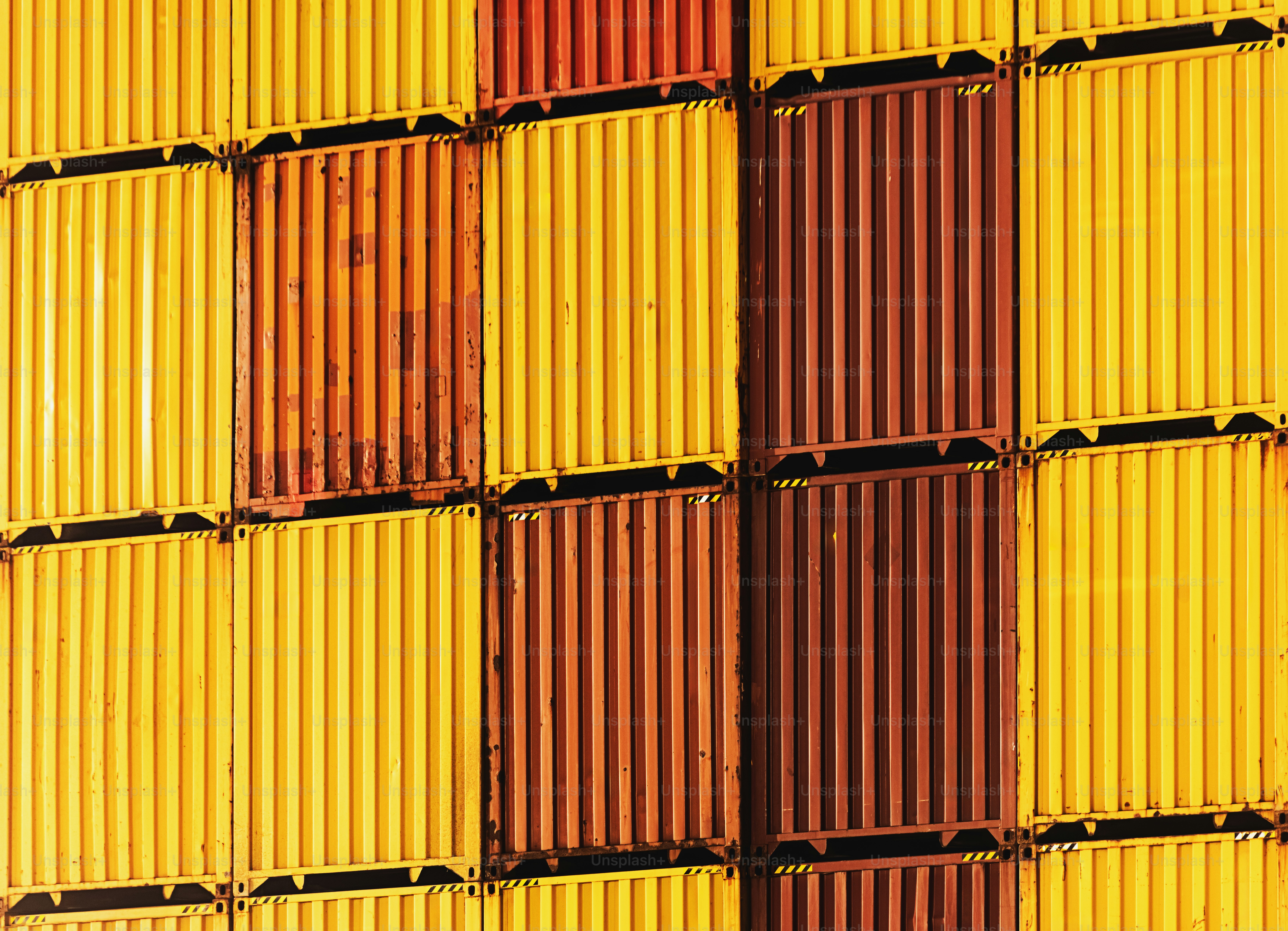Containers are stacked at a cargo terminal dock - Photo on Unsplash+