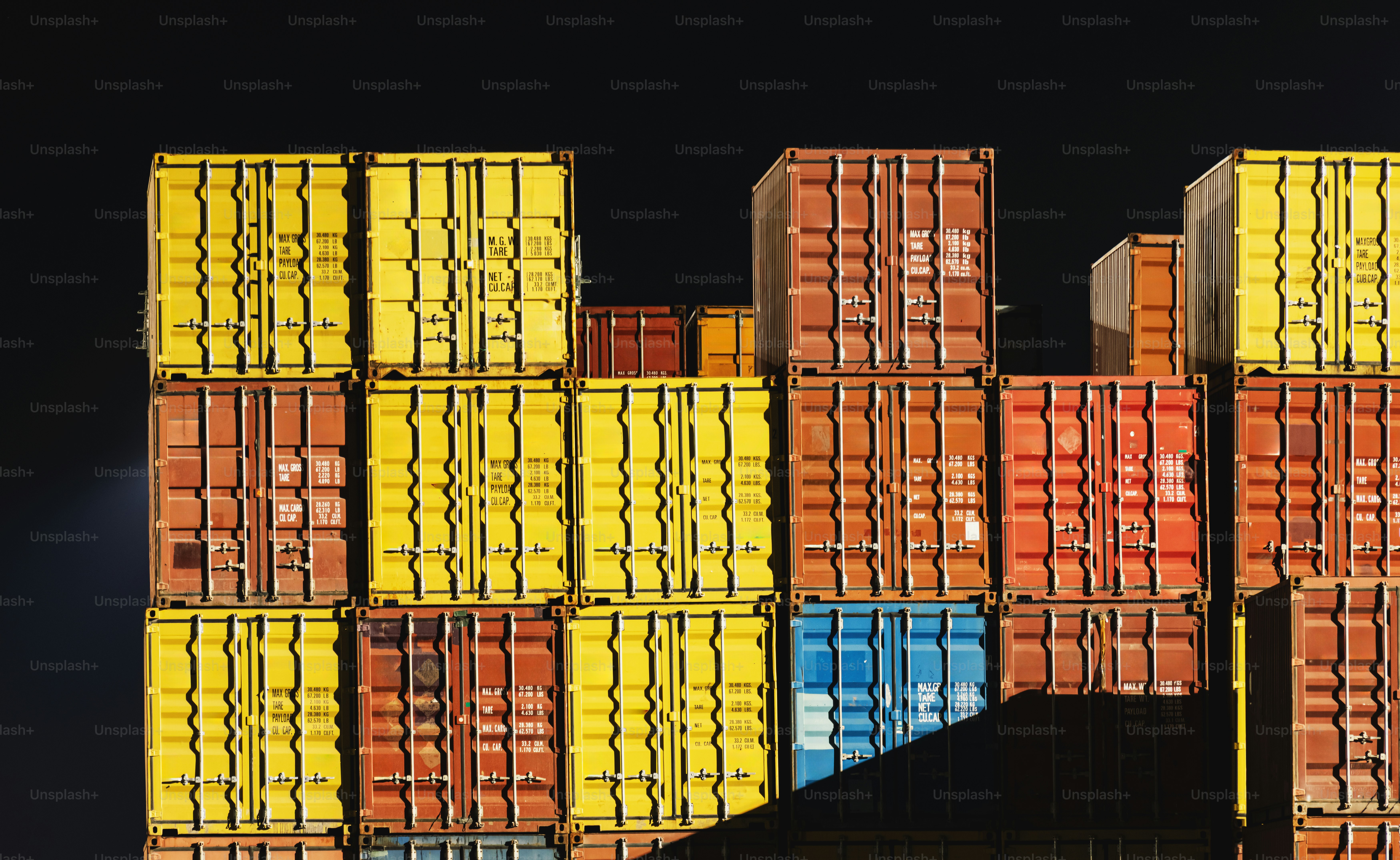 Containers are stacked at a cargo terminal dock. photo – Business Image ...