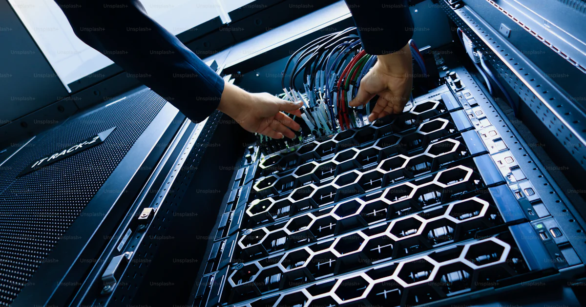 Organize Server Rack Hands organizing cables in server racks within a modern data center ...