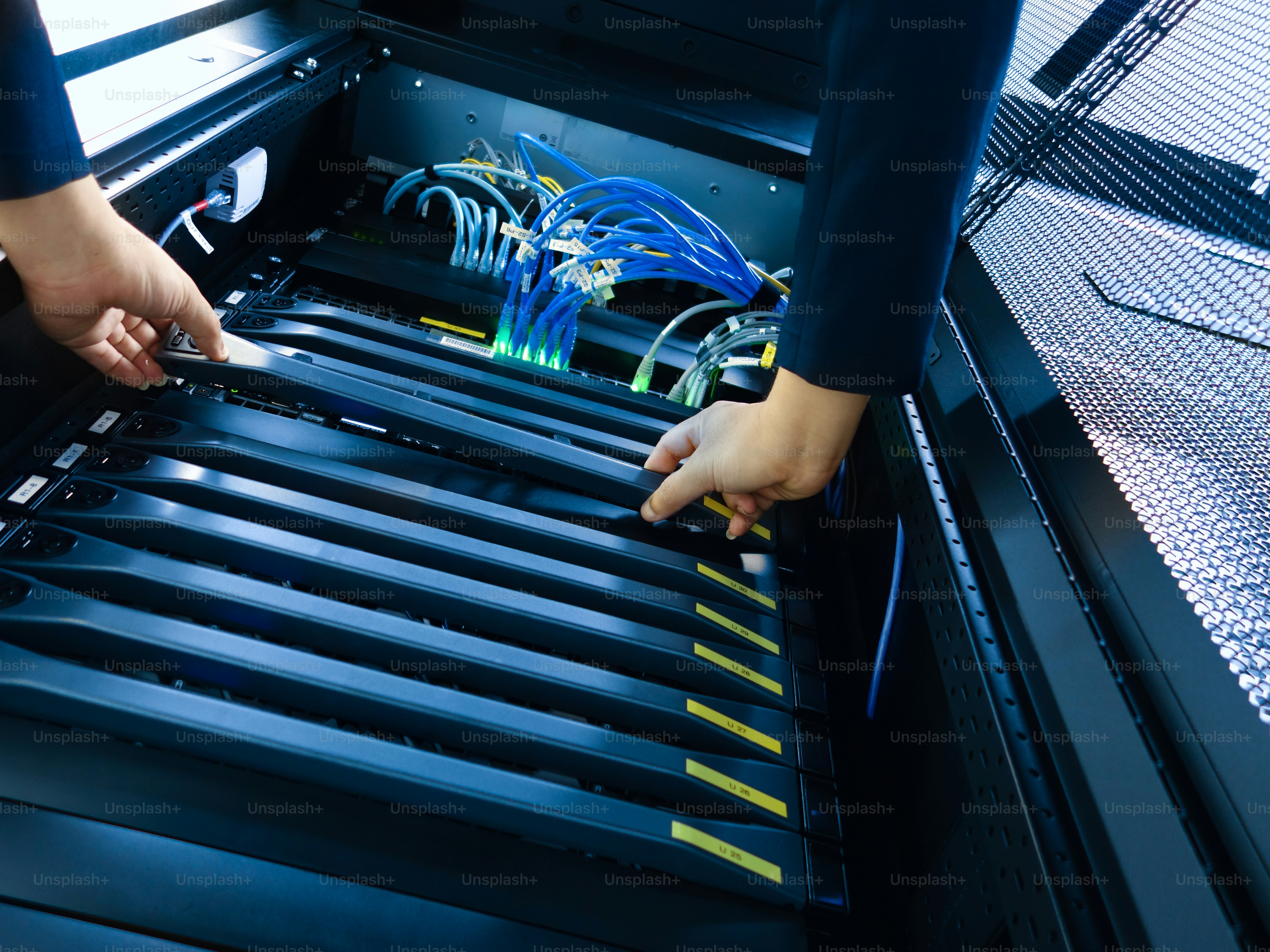 Un técnico realiza el mantenimiento en un rack de servidores, gestionando cables y asegurando la conectividad adecuada para un rendimiento óptimo en un entorno de centro de datos.