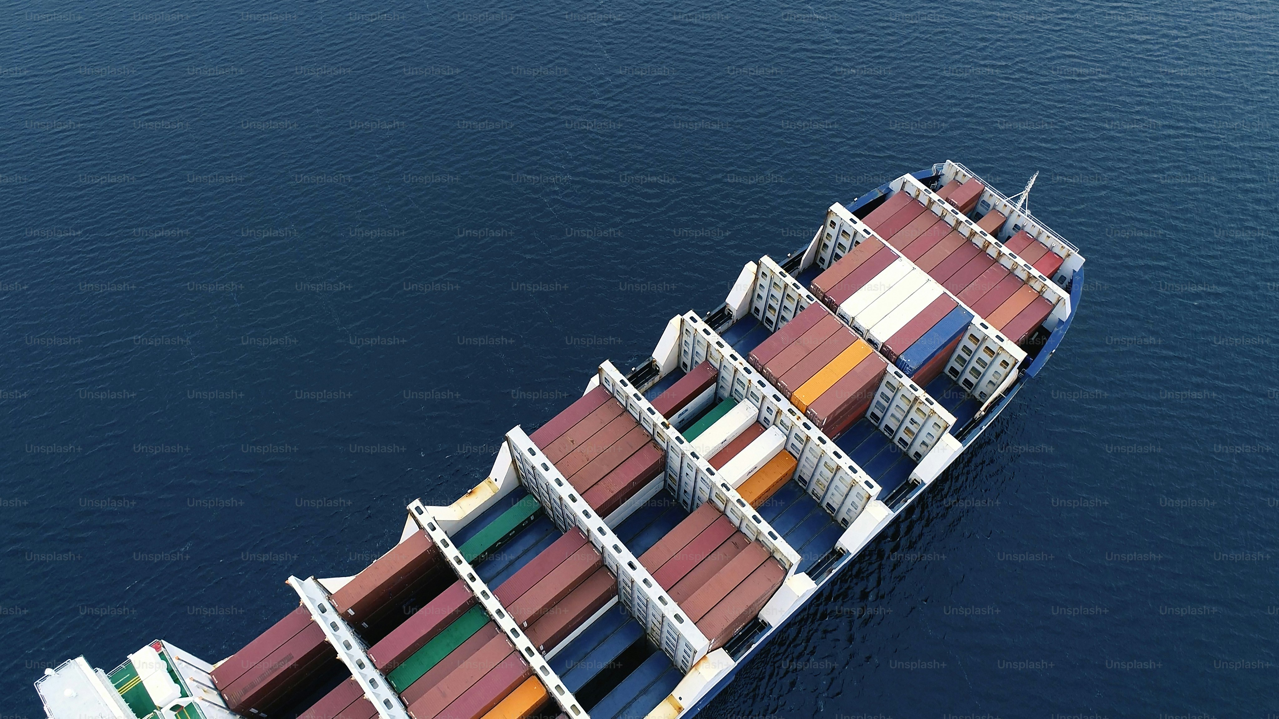 Aerial view of a container ship navigating a harbour. photo – Sea Image ...