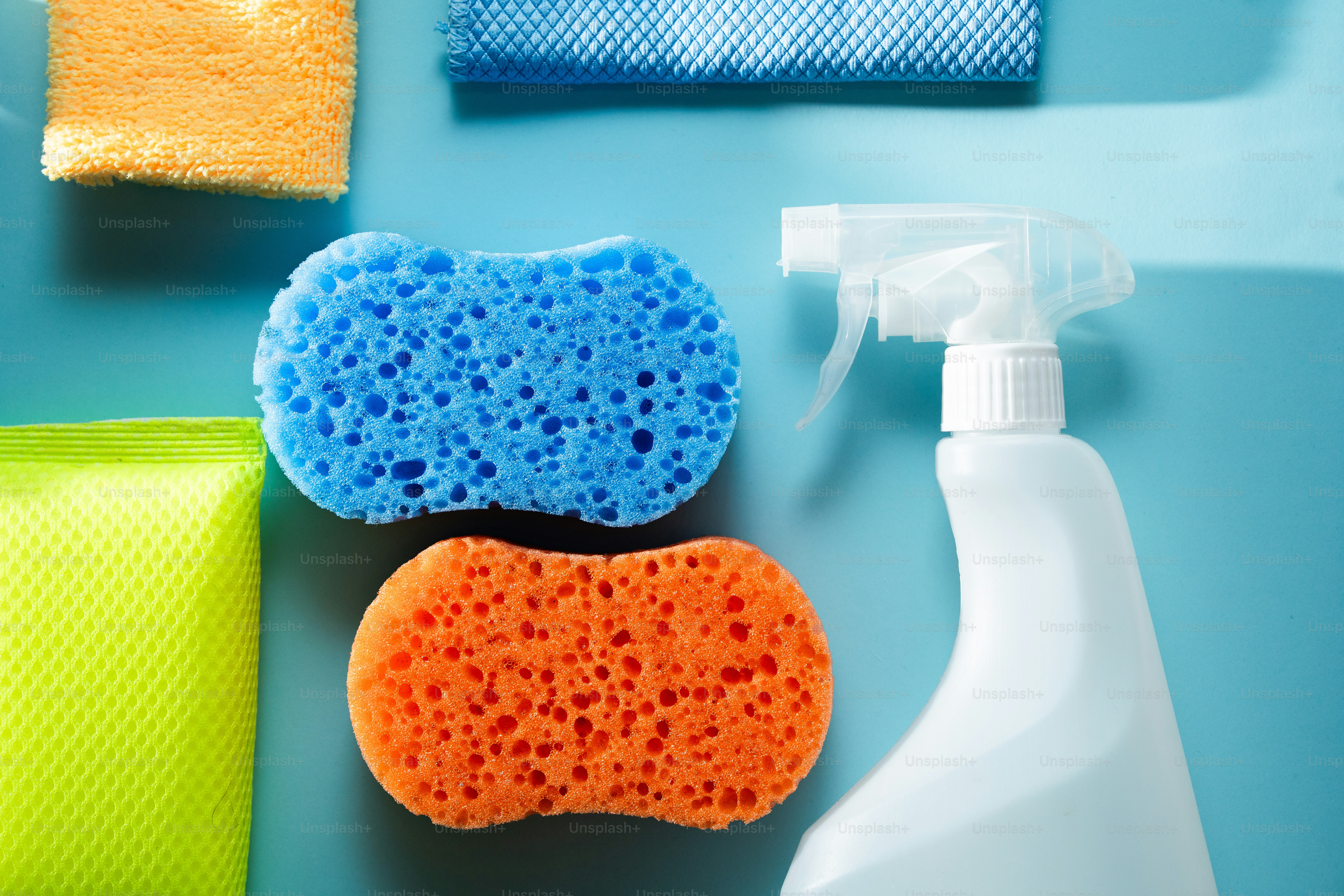 Cleaning supplies with sponges and spray bottle