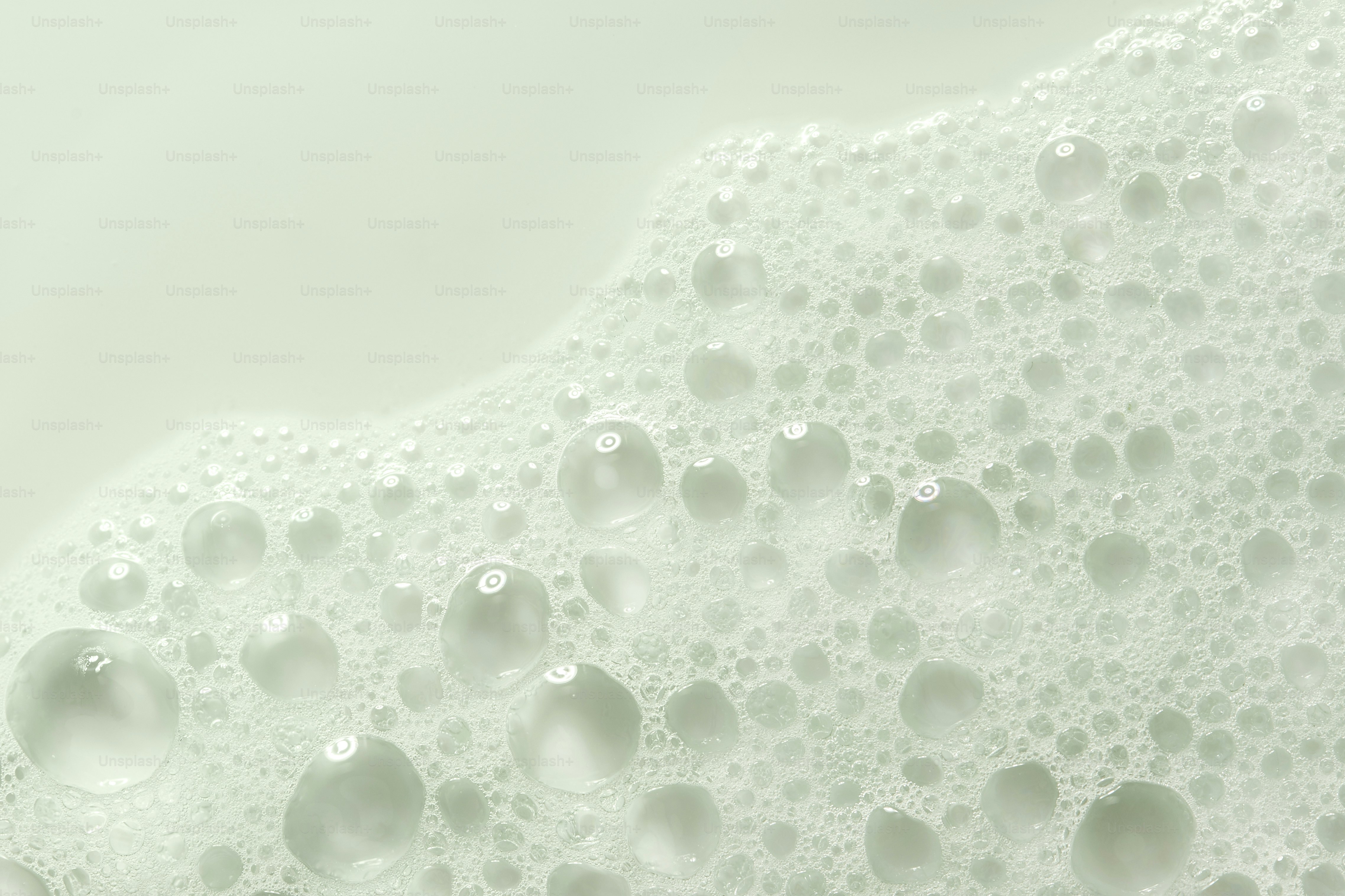 Close-up of white soap bubbles on a light background