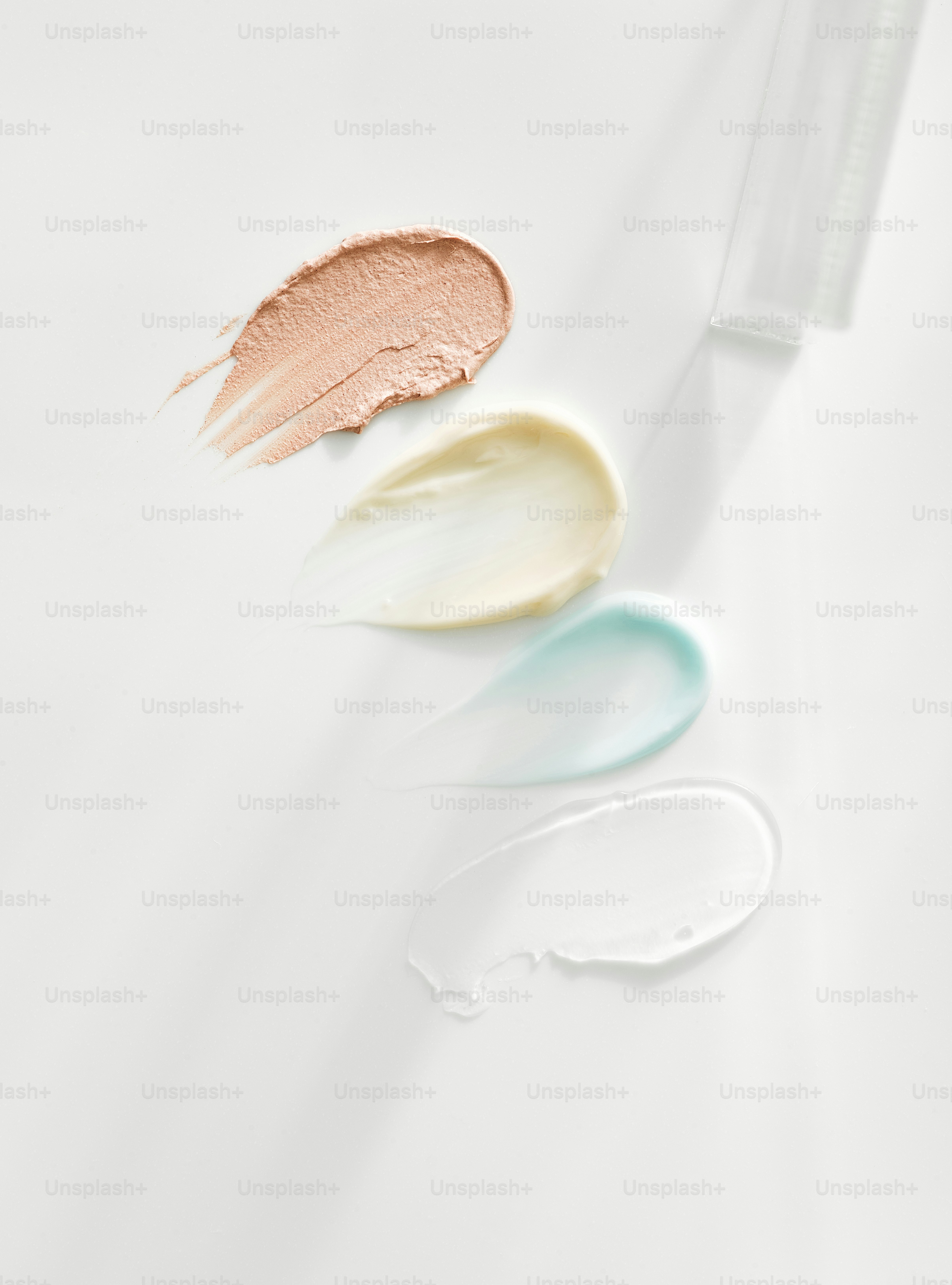 Swatches of cosmetic creams on a white surface