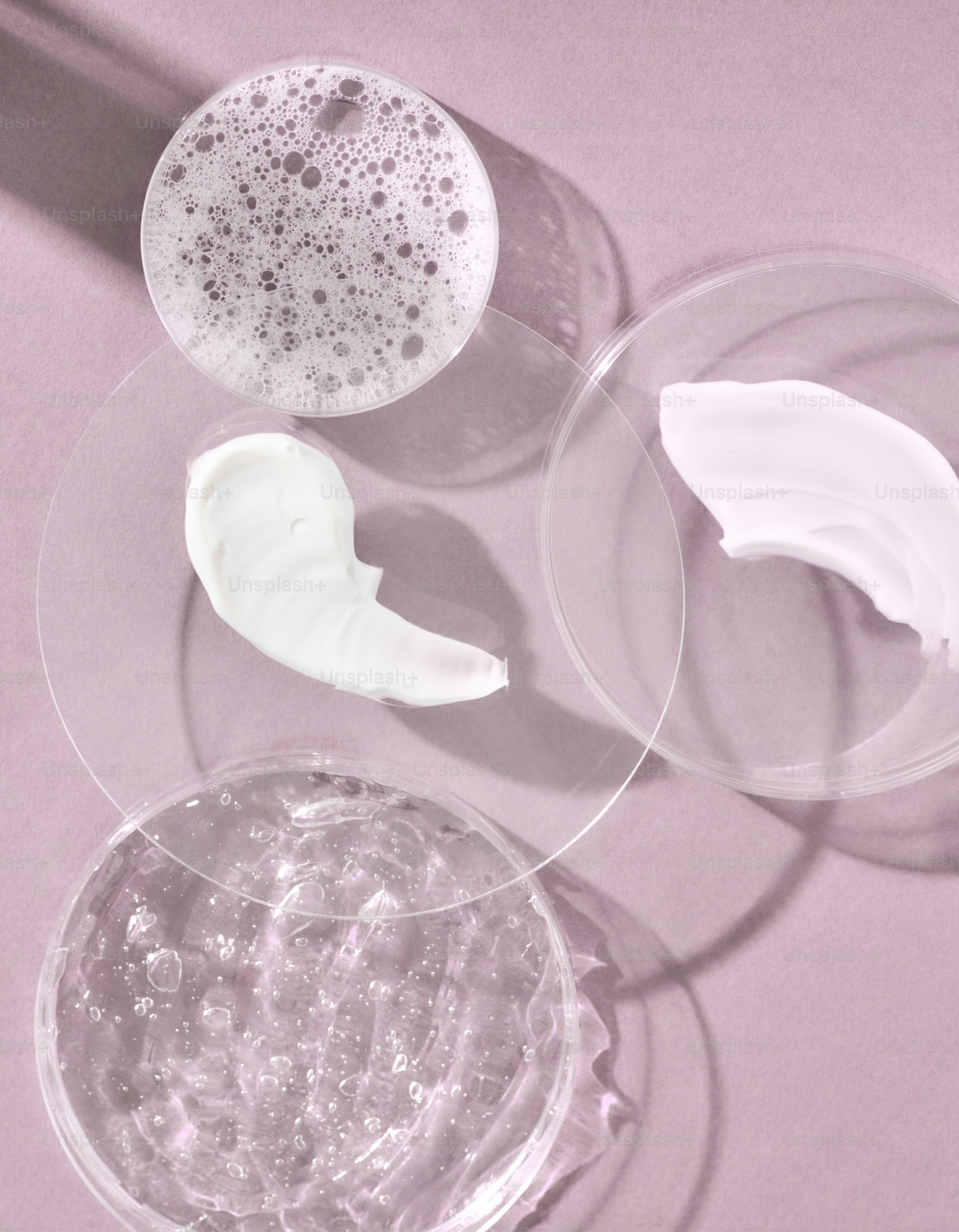 Skincare products in petri dishes with shadows