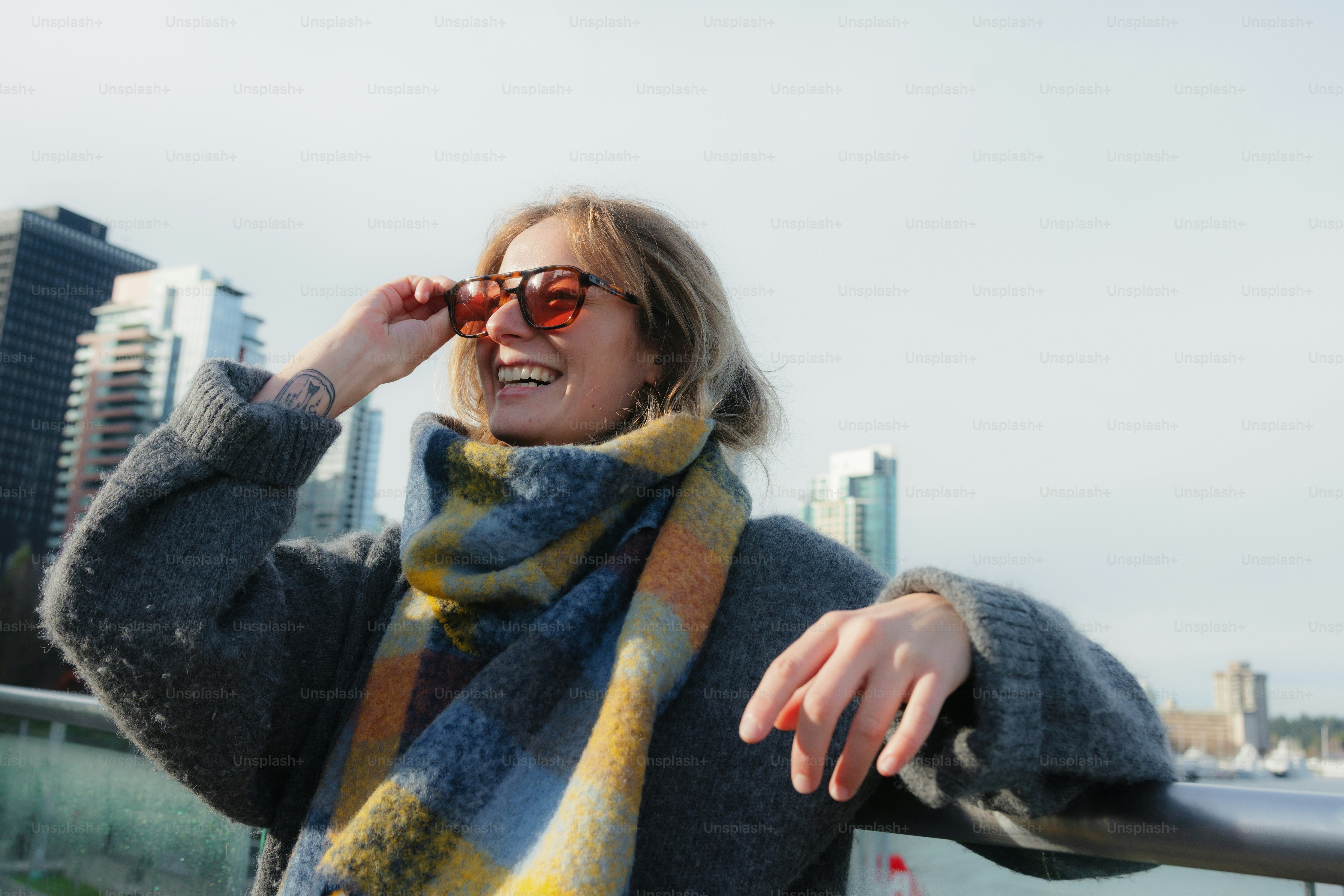 Woman wearing scarf and sunglasses looking away