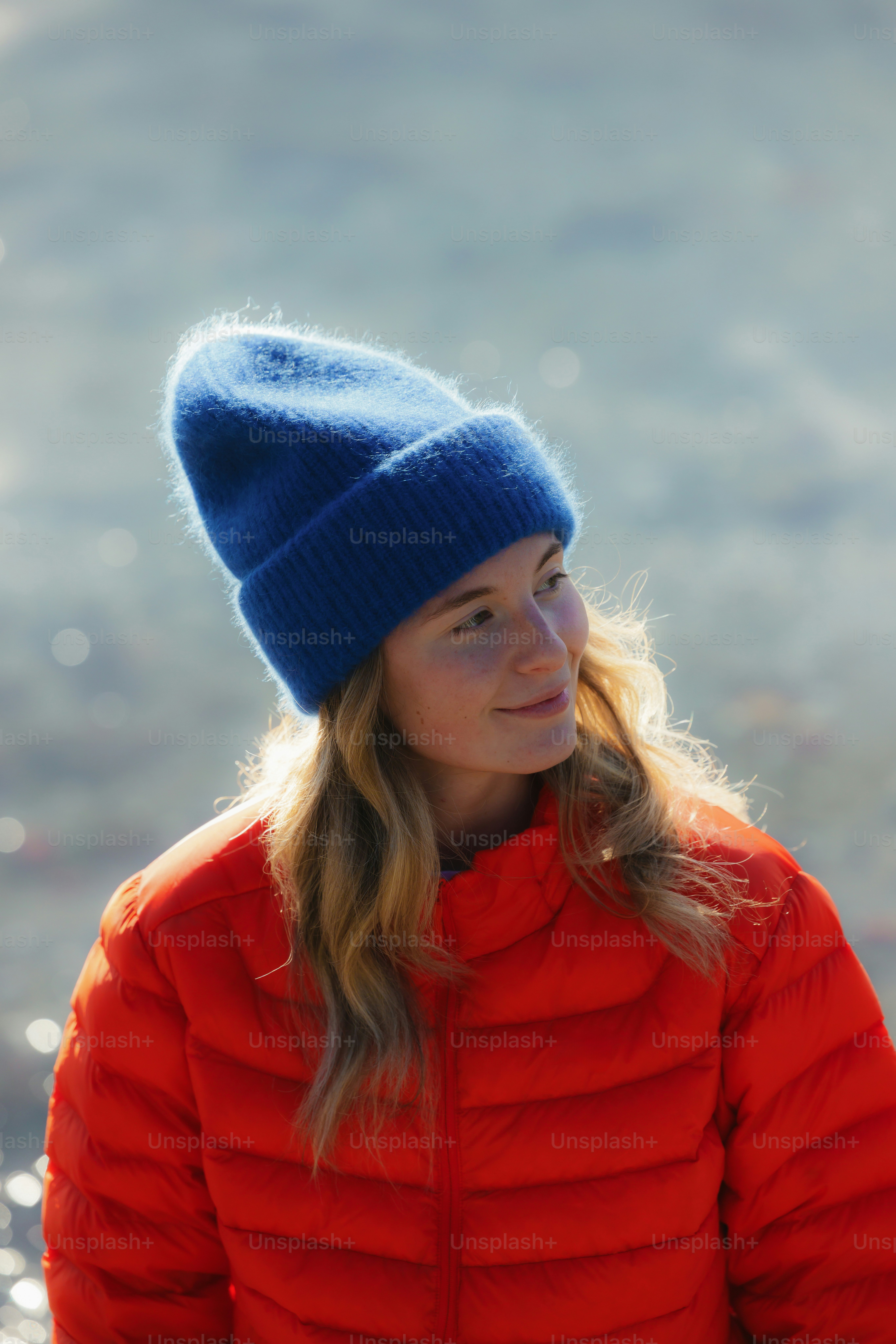 Young woman in a blue hat and red jacket