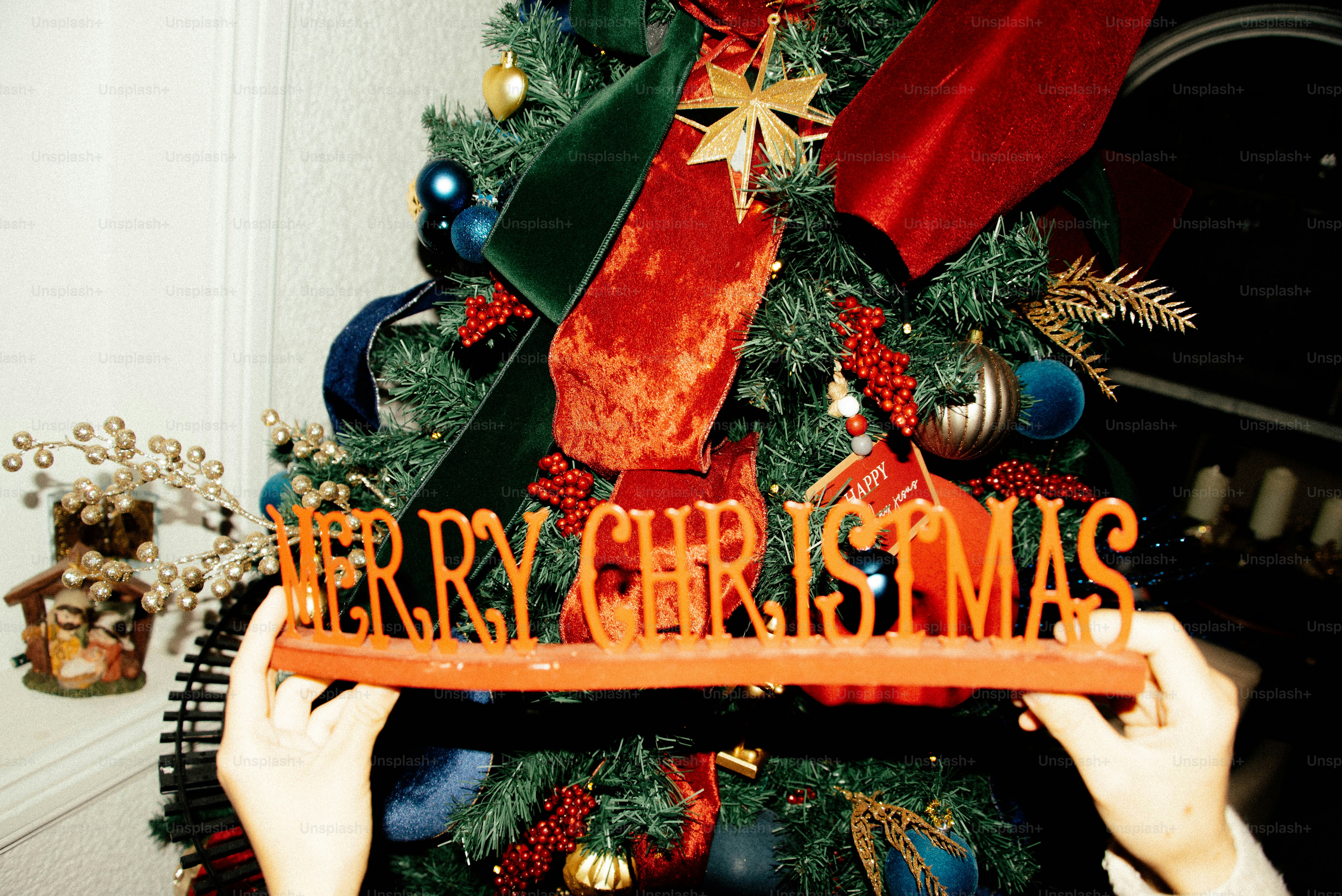 Hands hold merry christmas sign near decorated tree photo – Christmas ...