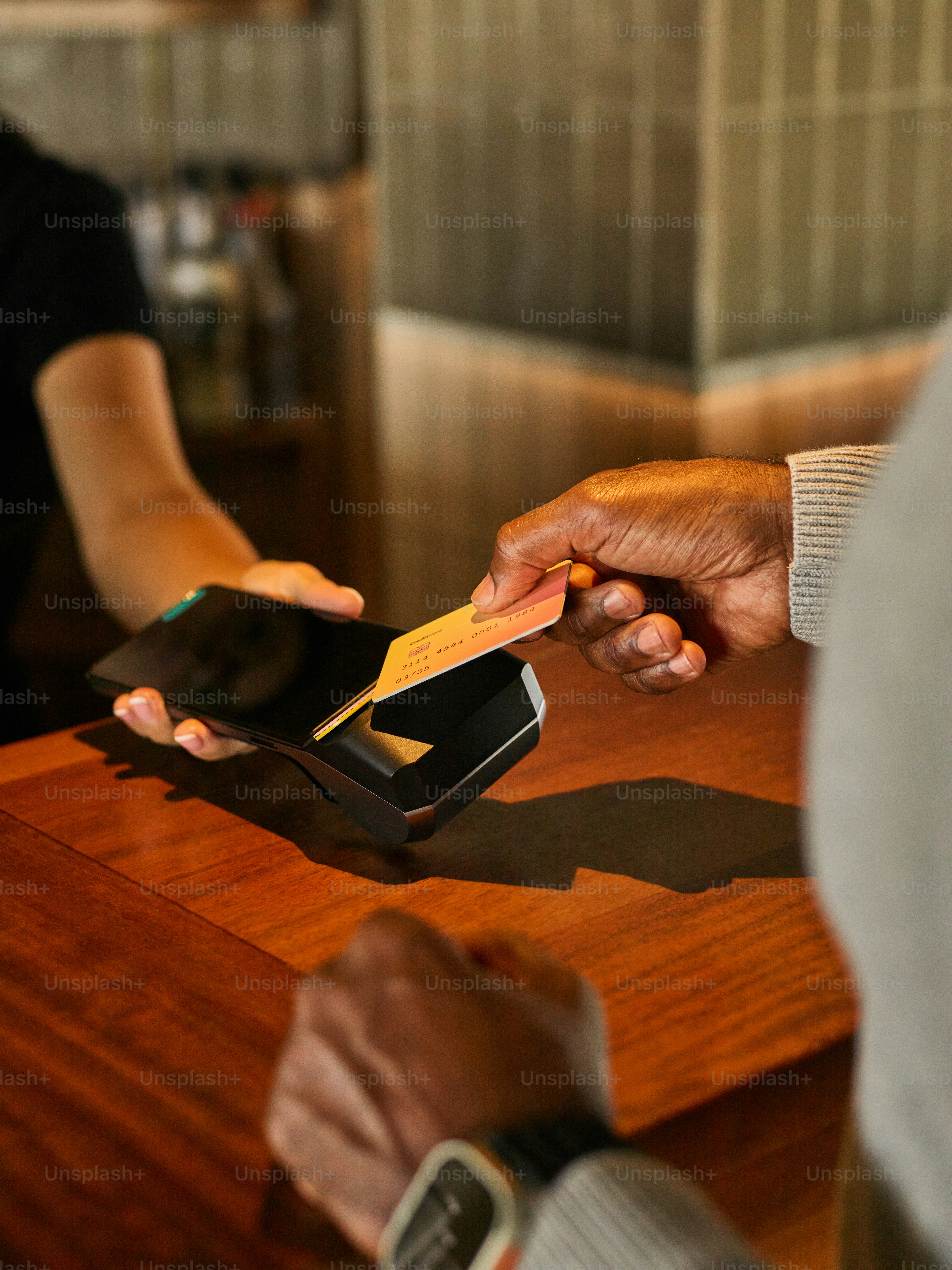 Customer paying with credit card at point of sale.