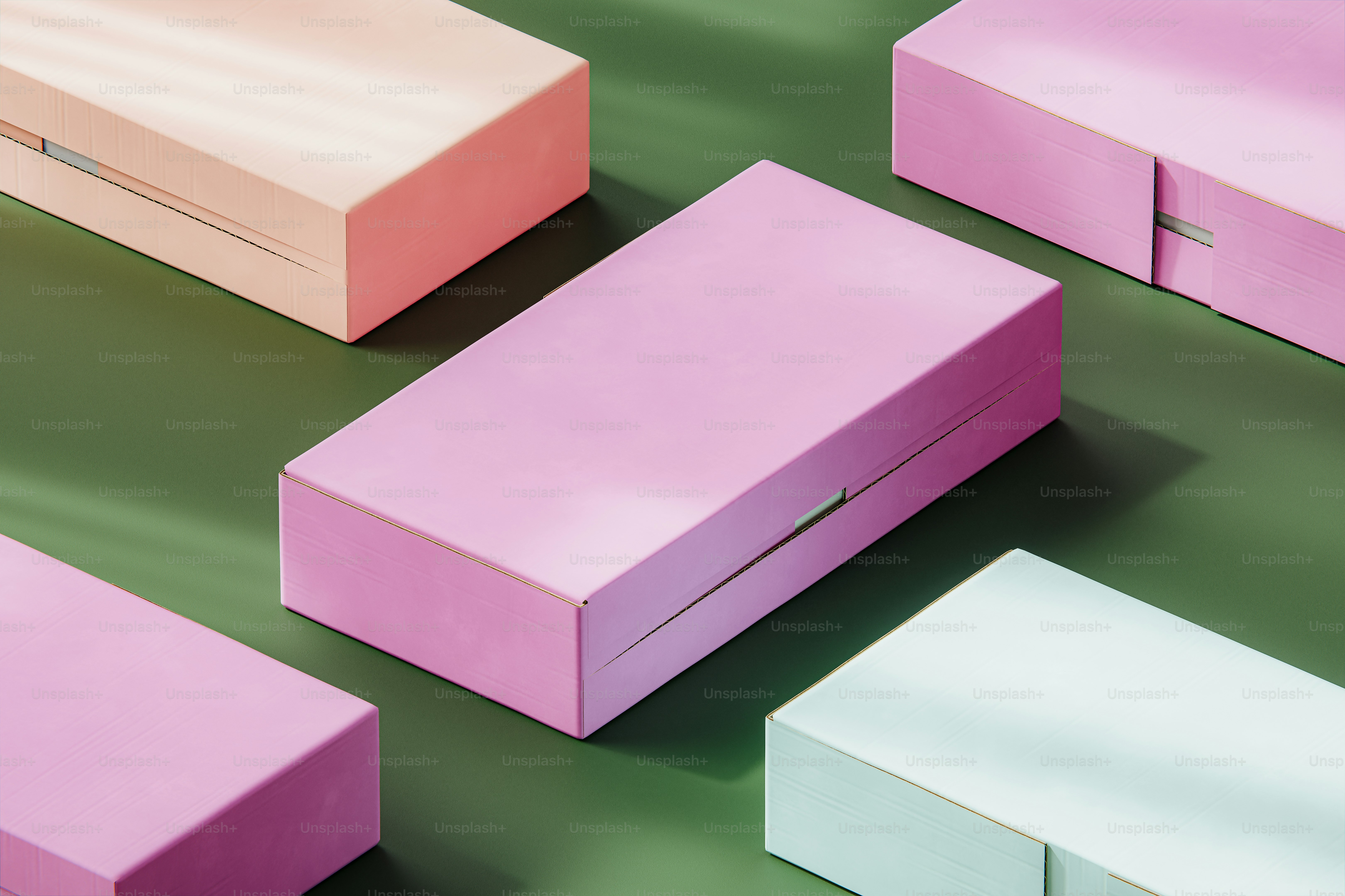 Pastel colored boxes arranged on a green surface.