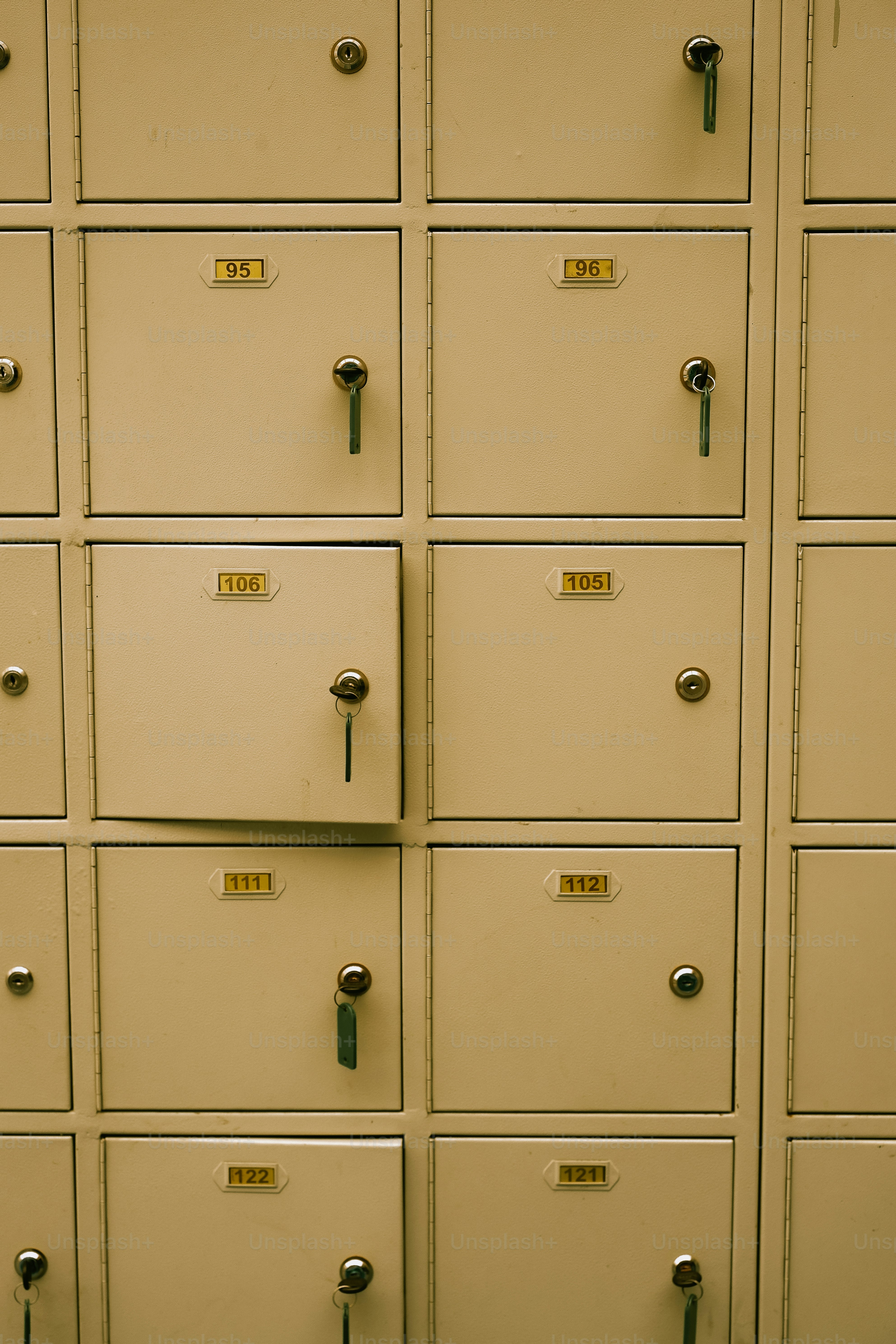 A wall of beige lockers with numbered doors.