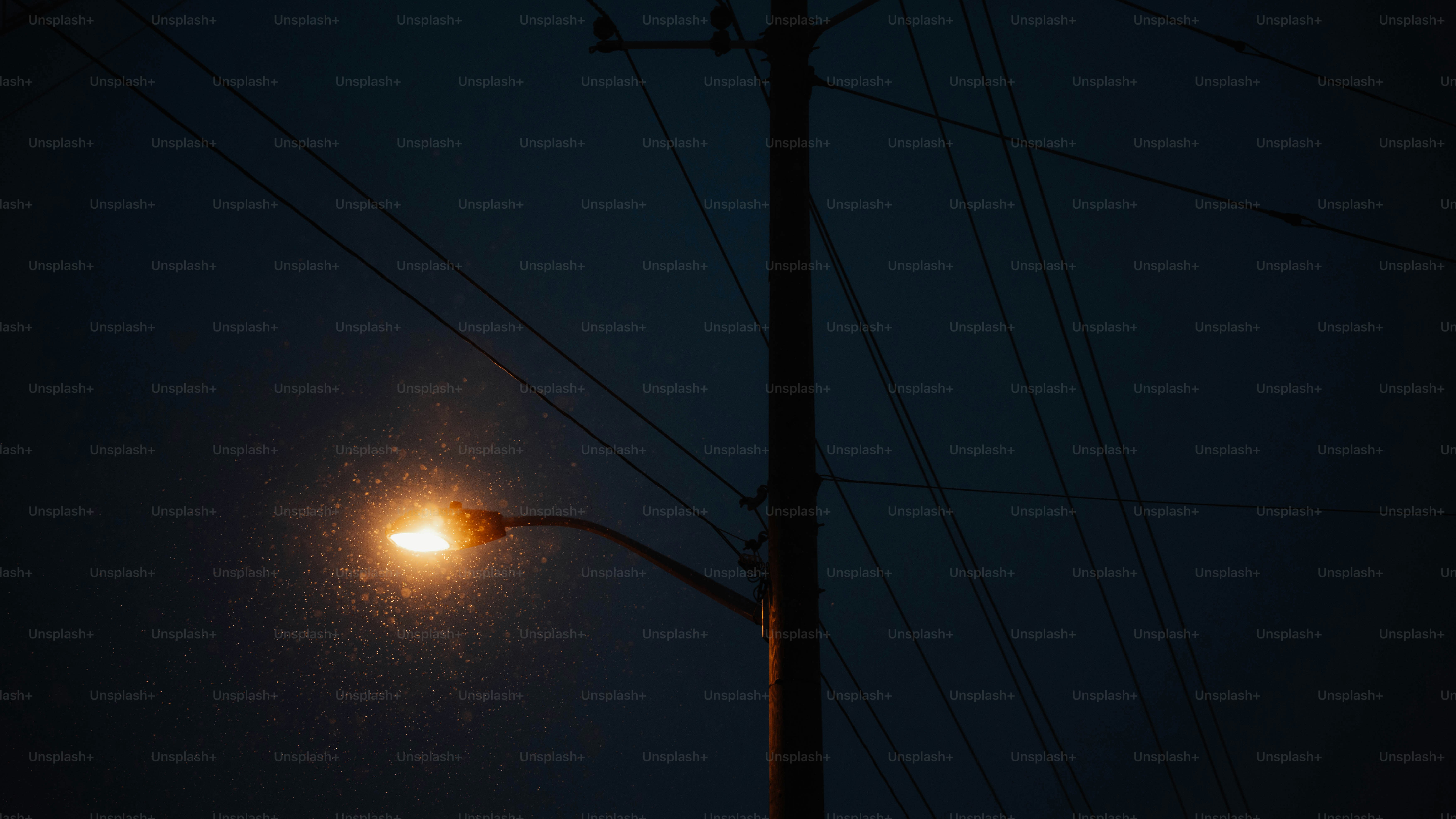 Streetlight illuminated at dusk with rain