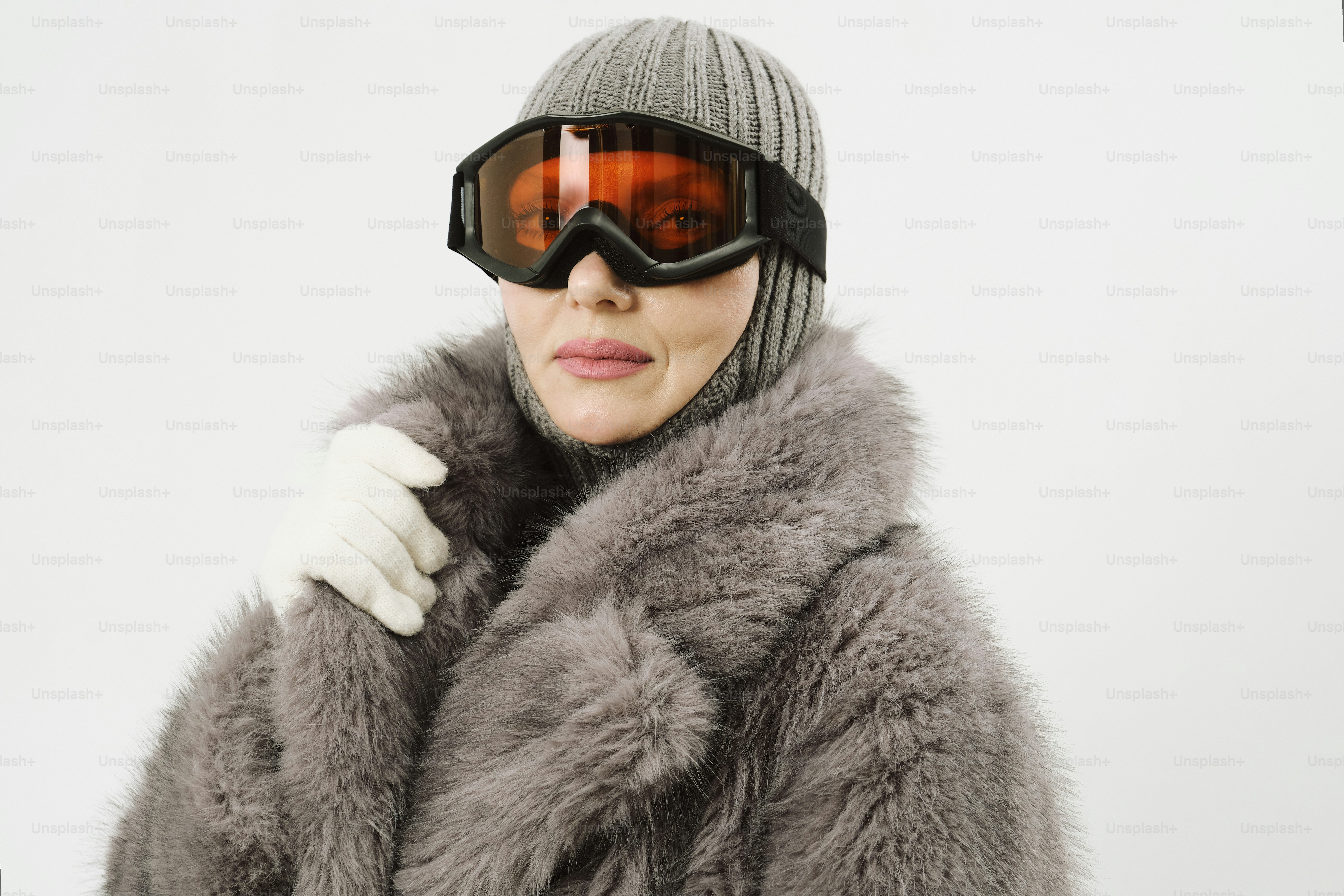 Woman in ski goggles and fur coat