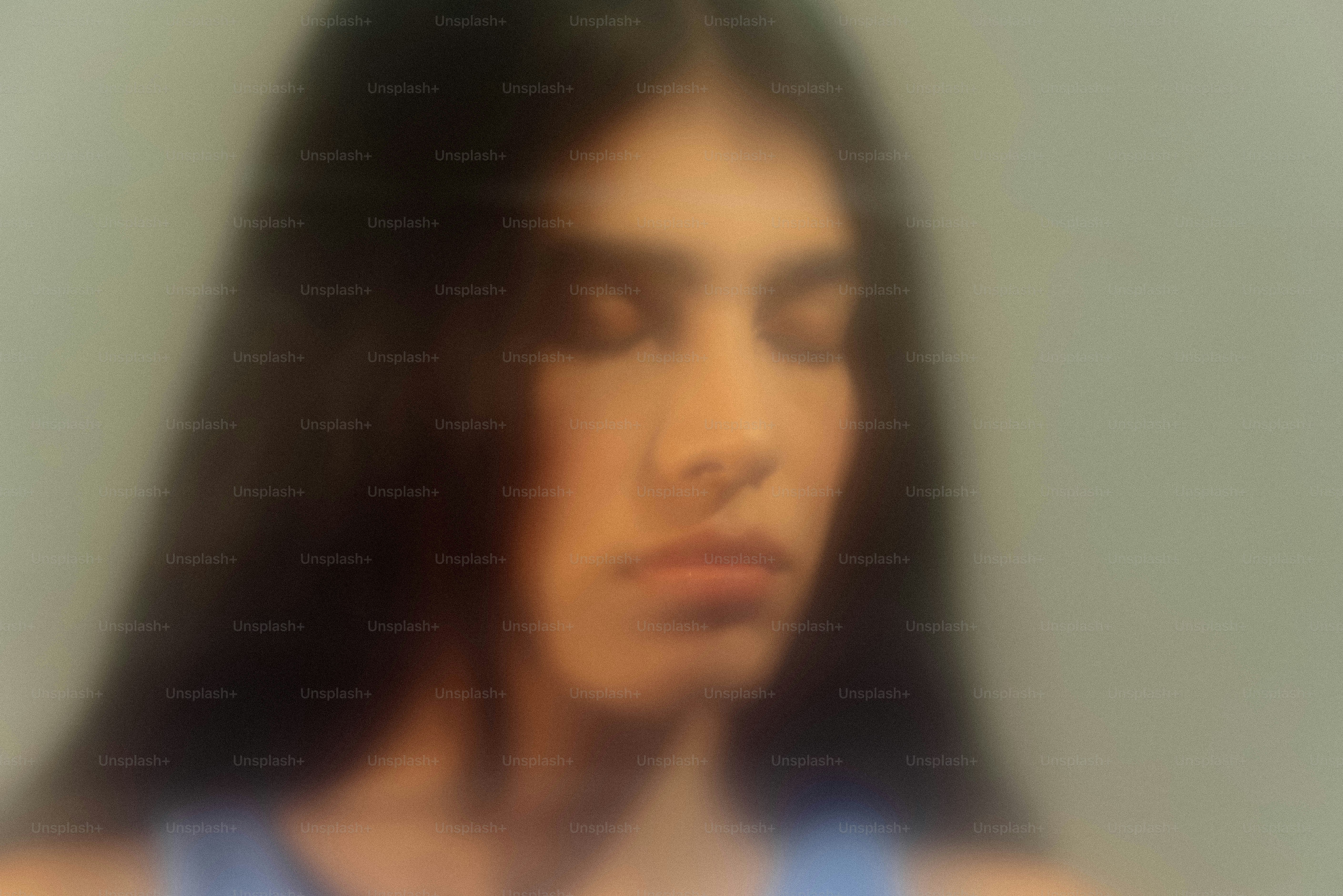 A young person with eyes closed, soft focus.