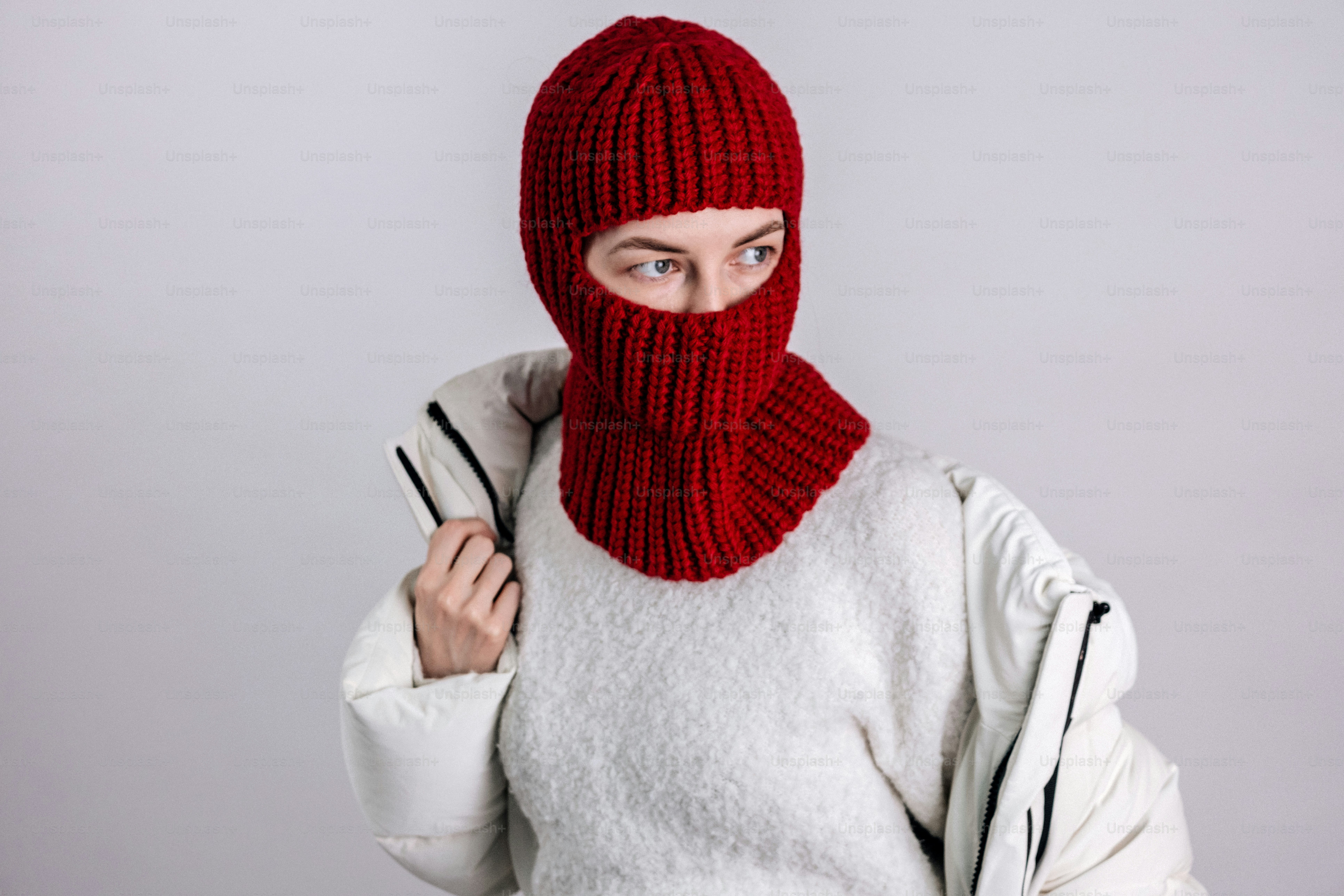 Person in a white puffer jacket and red ski mask. photo – Clothing ...
