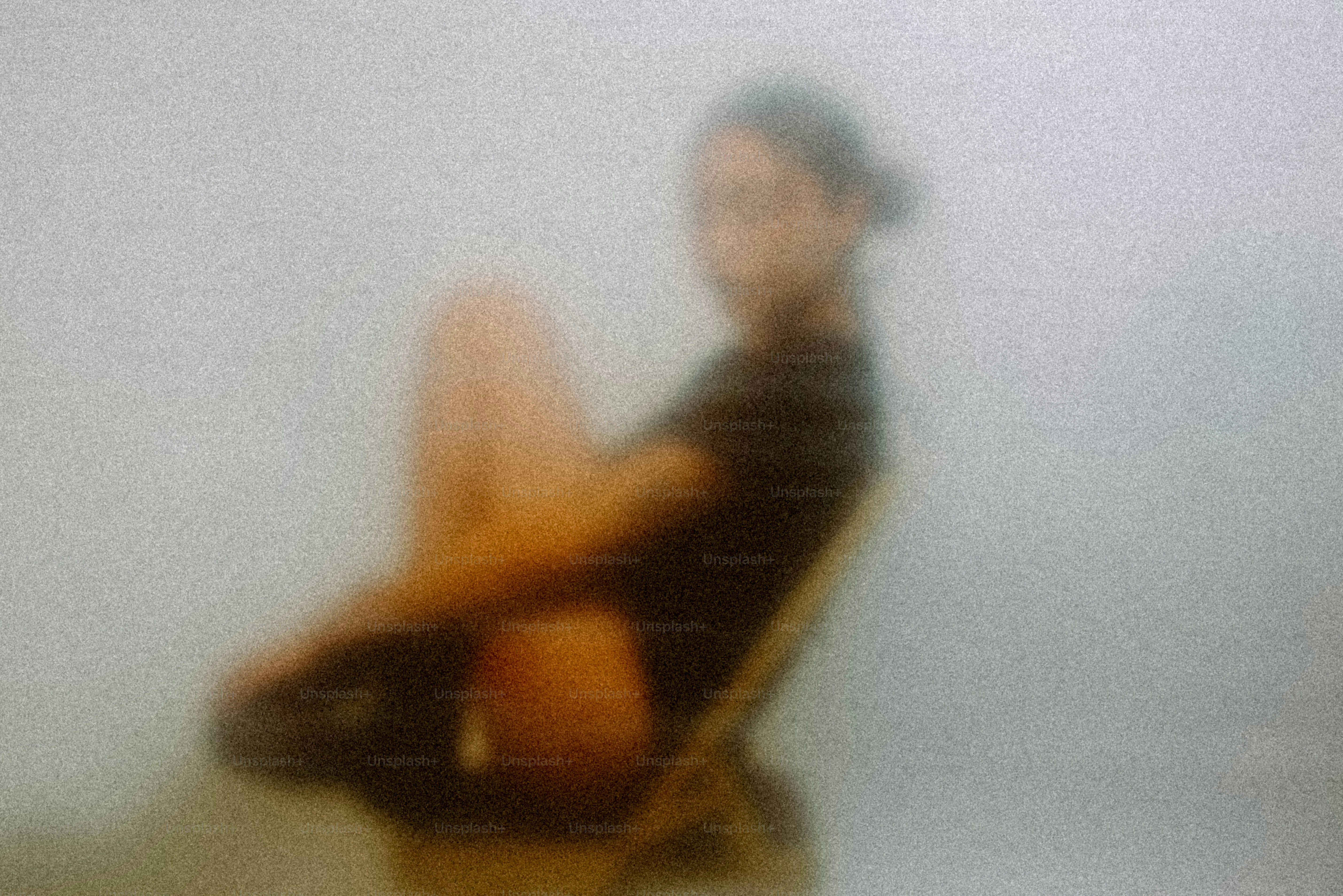 A woman sits with knees pulled to chest