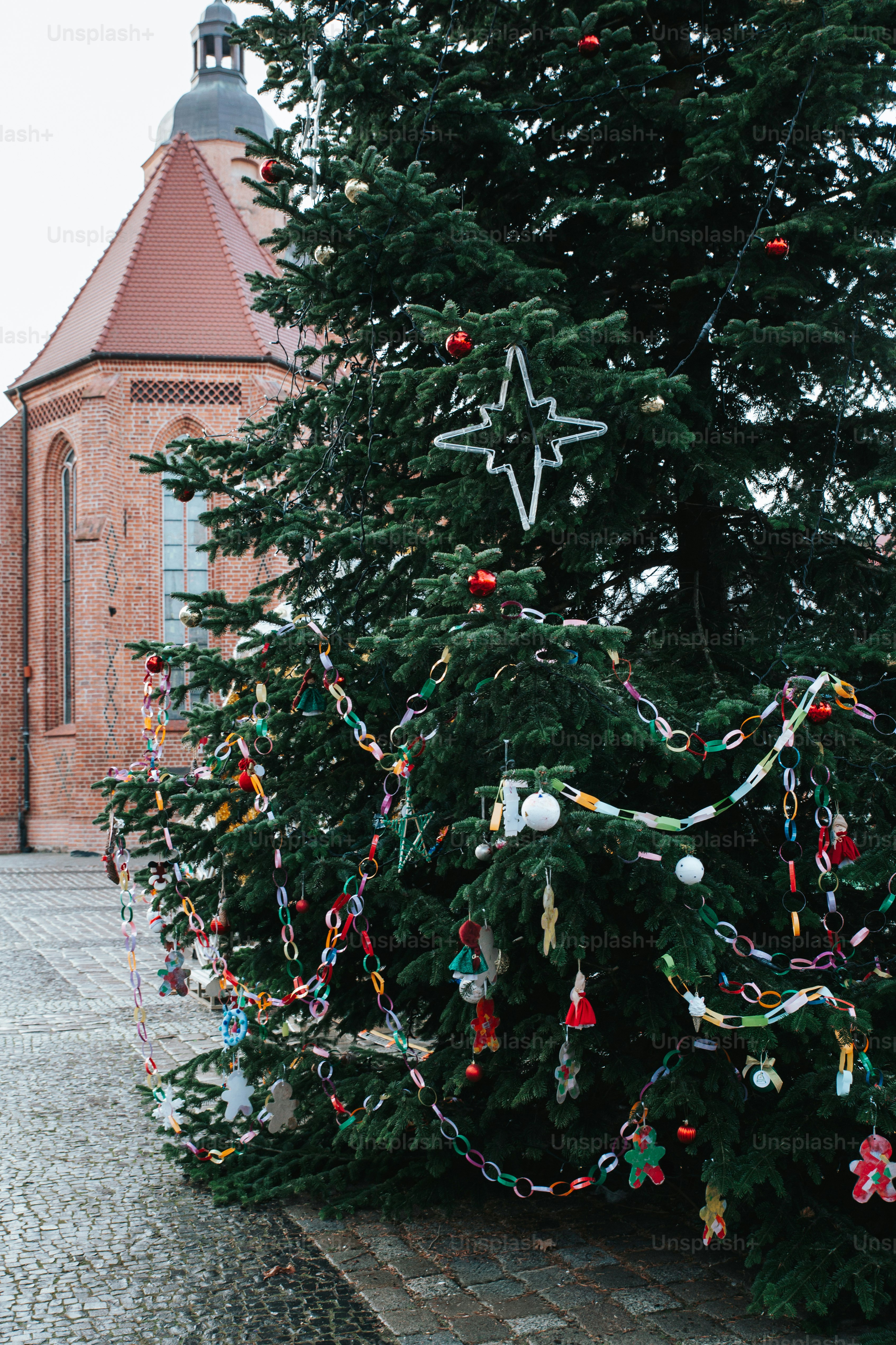 Decorated christmas tree in front of brick building