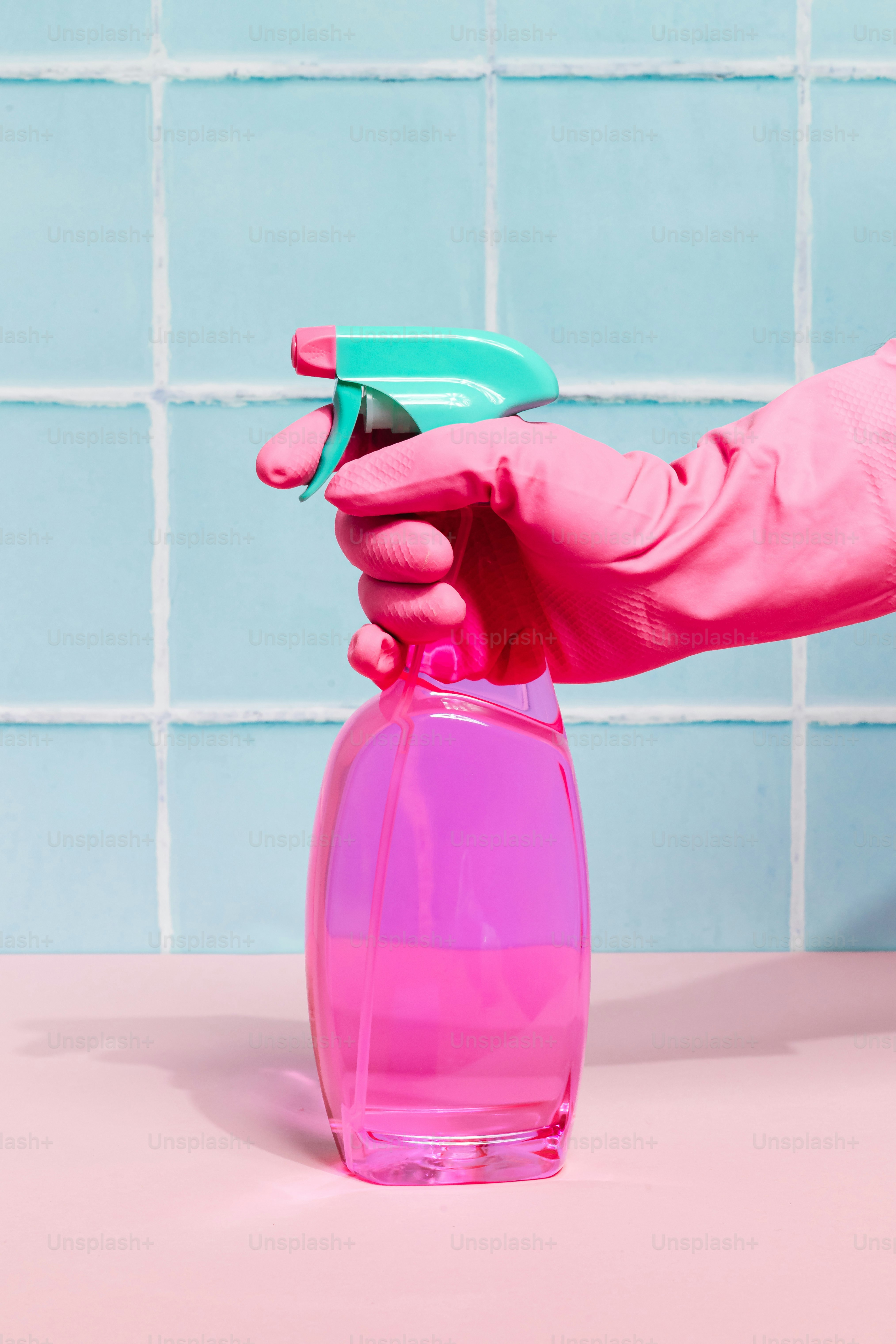 Hand in pink glove holding pink spray bottle photo – Minimalist Image ...