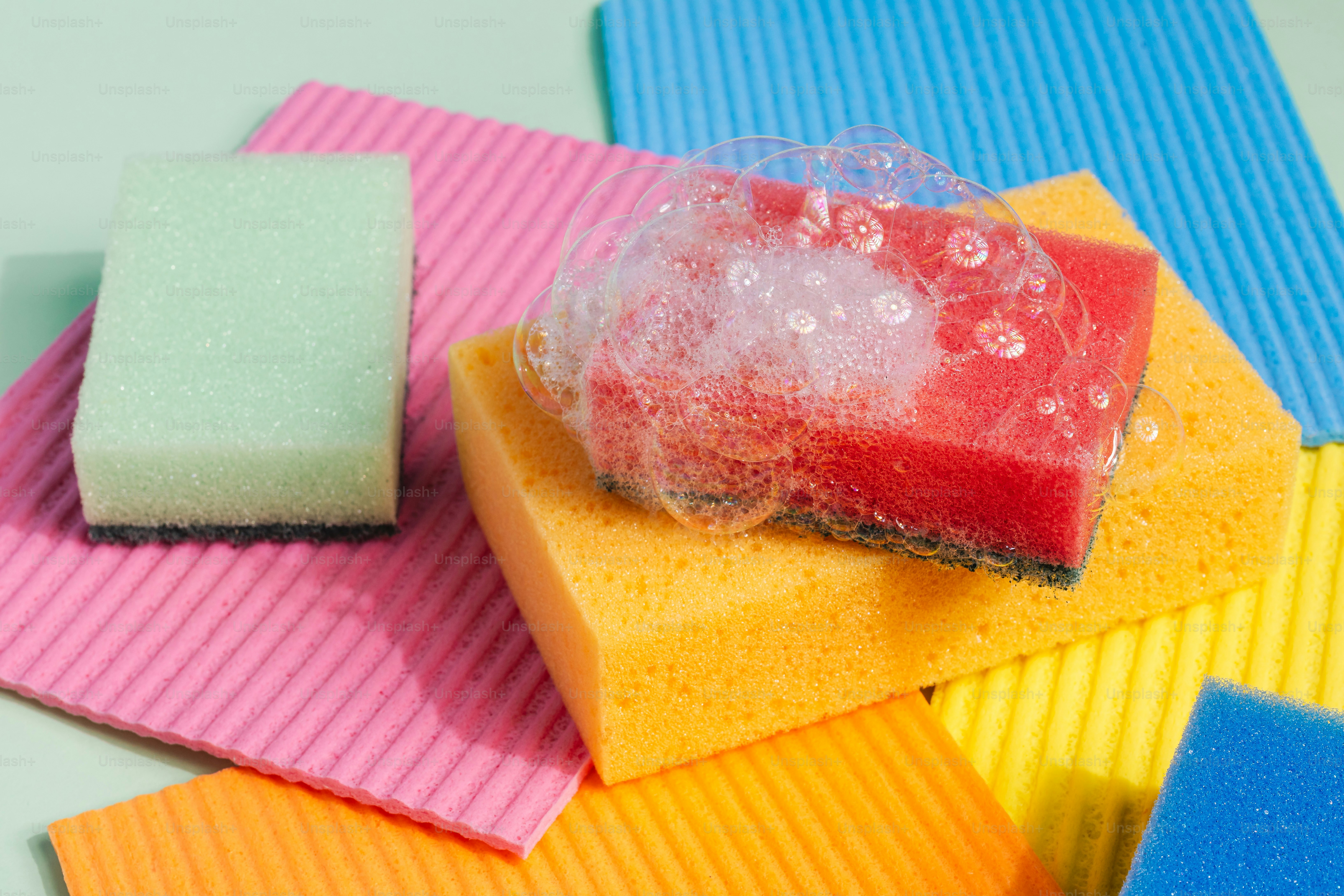 Colorful sponges with soap bubbles