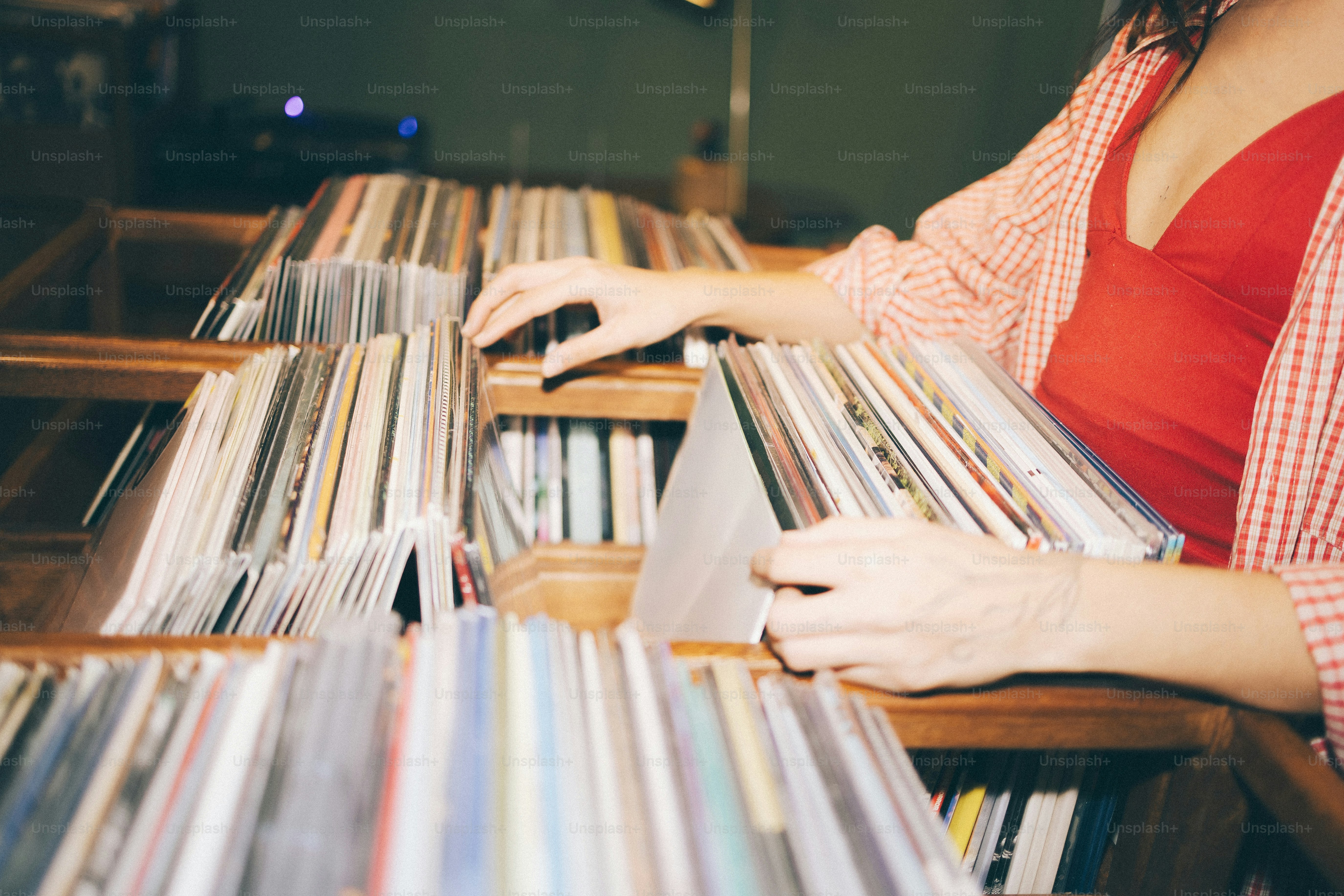 Woman browsing through vinyl records in a store