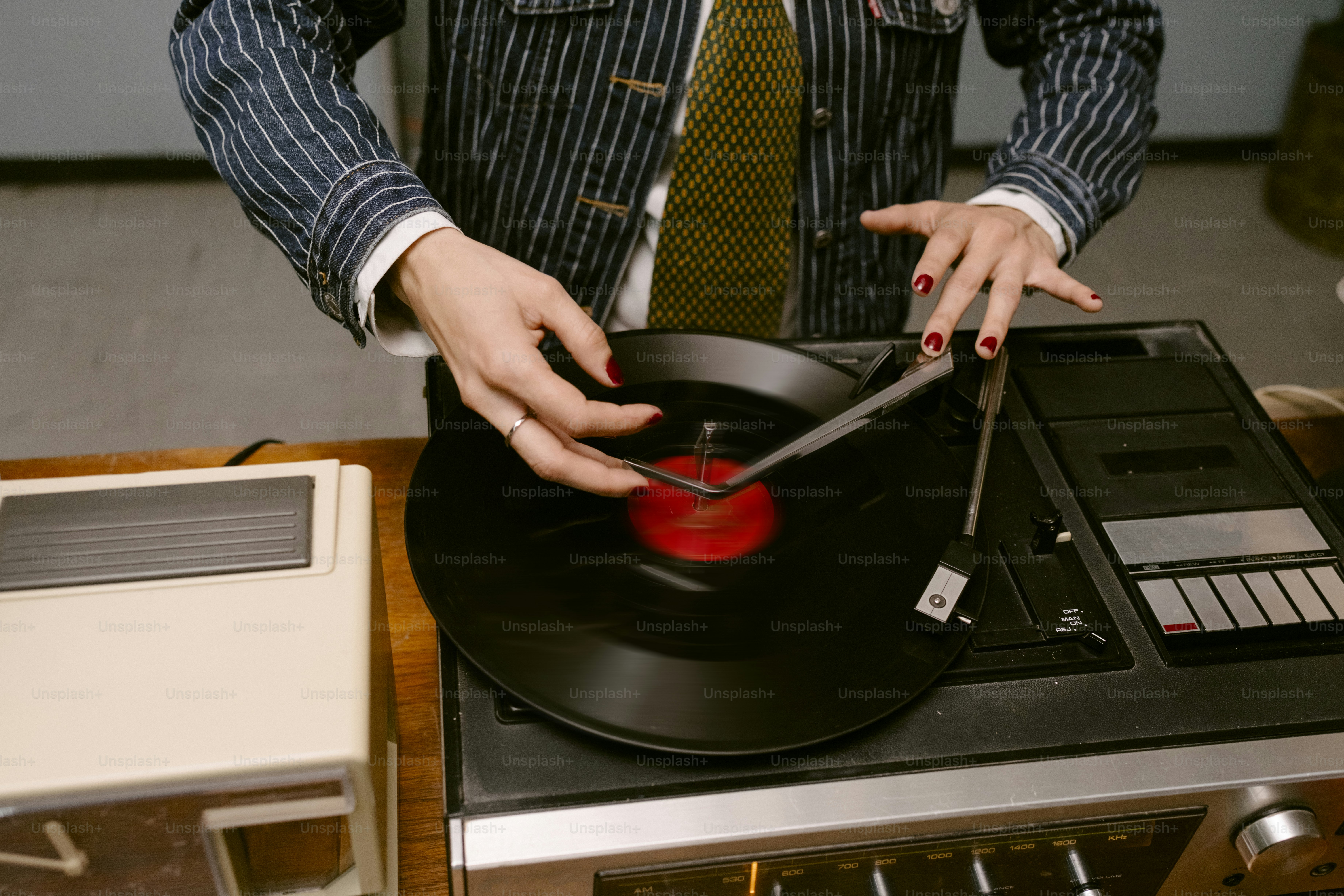 Persona che mette un ago su un disco in vinile
